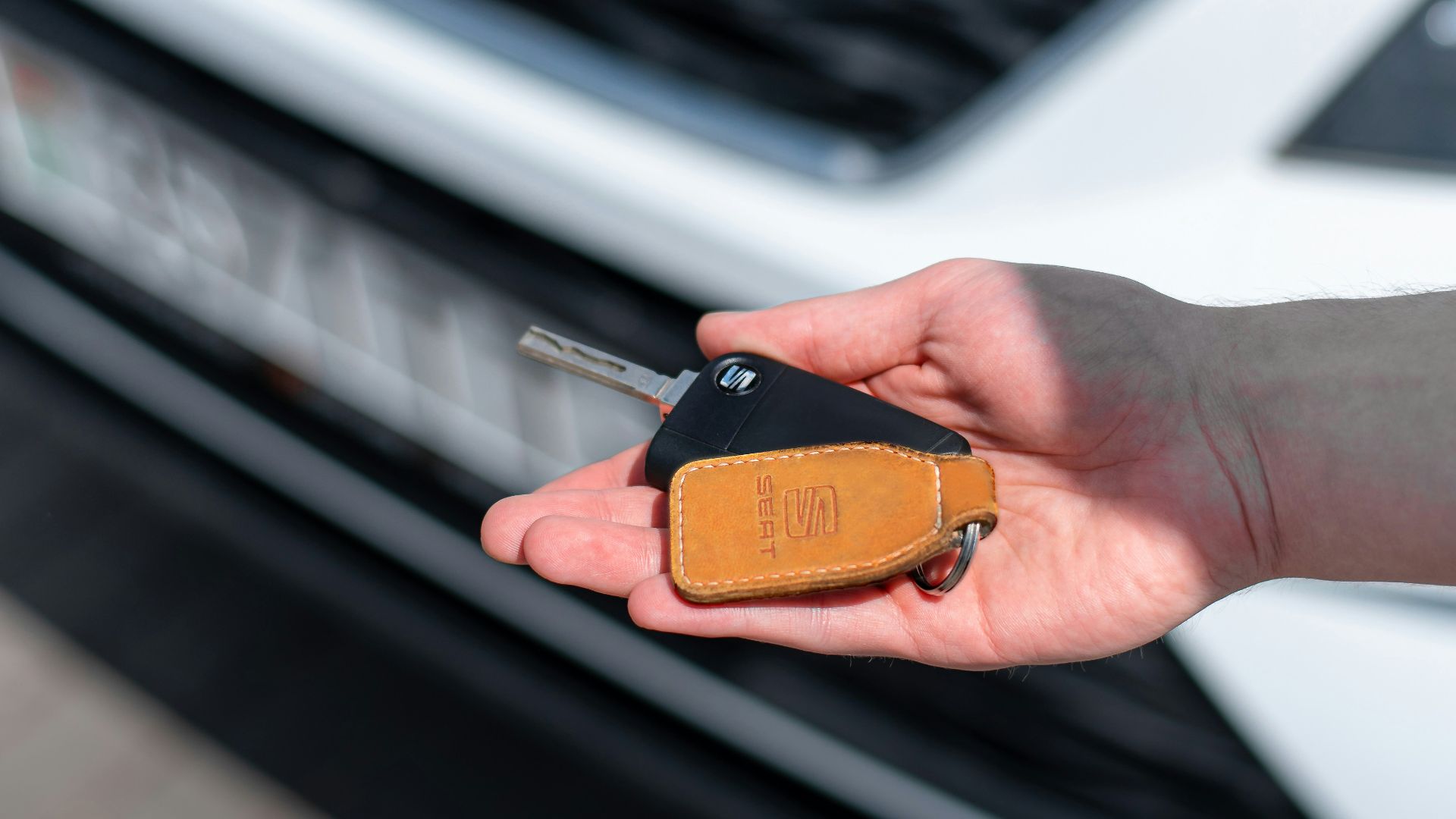 a person holding a car key in their hand