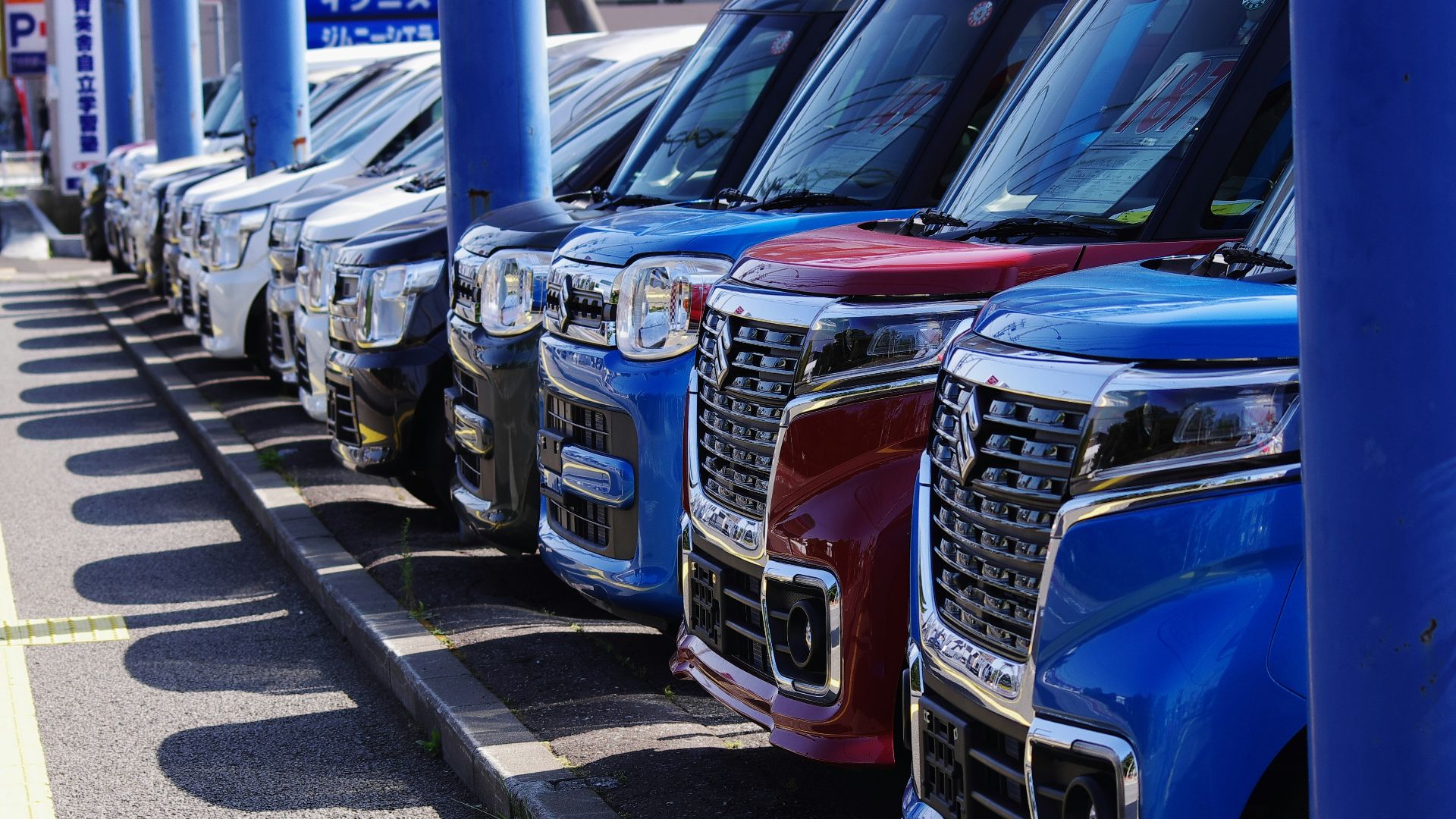 blue and silver cars on parking lot during daytime