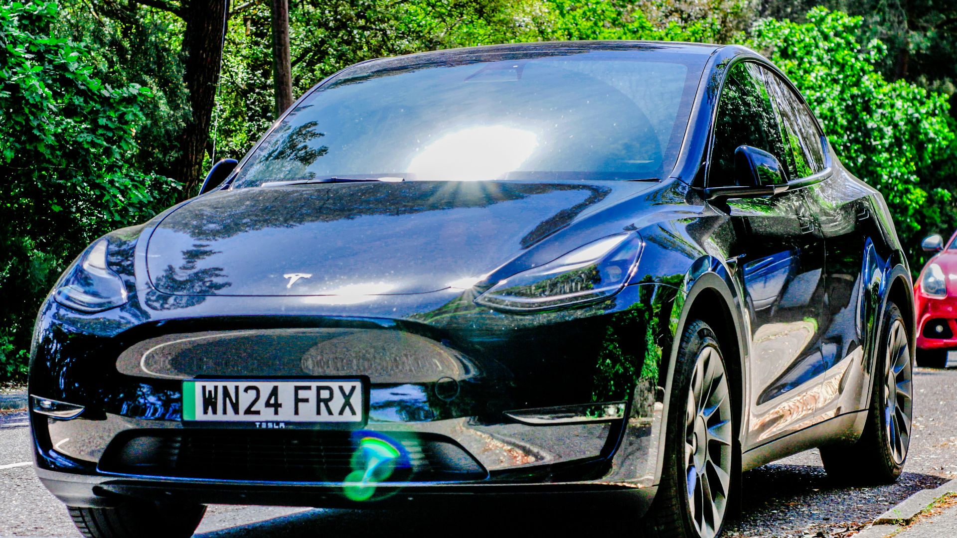 Two cars are parked on the side of the road