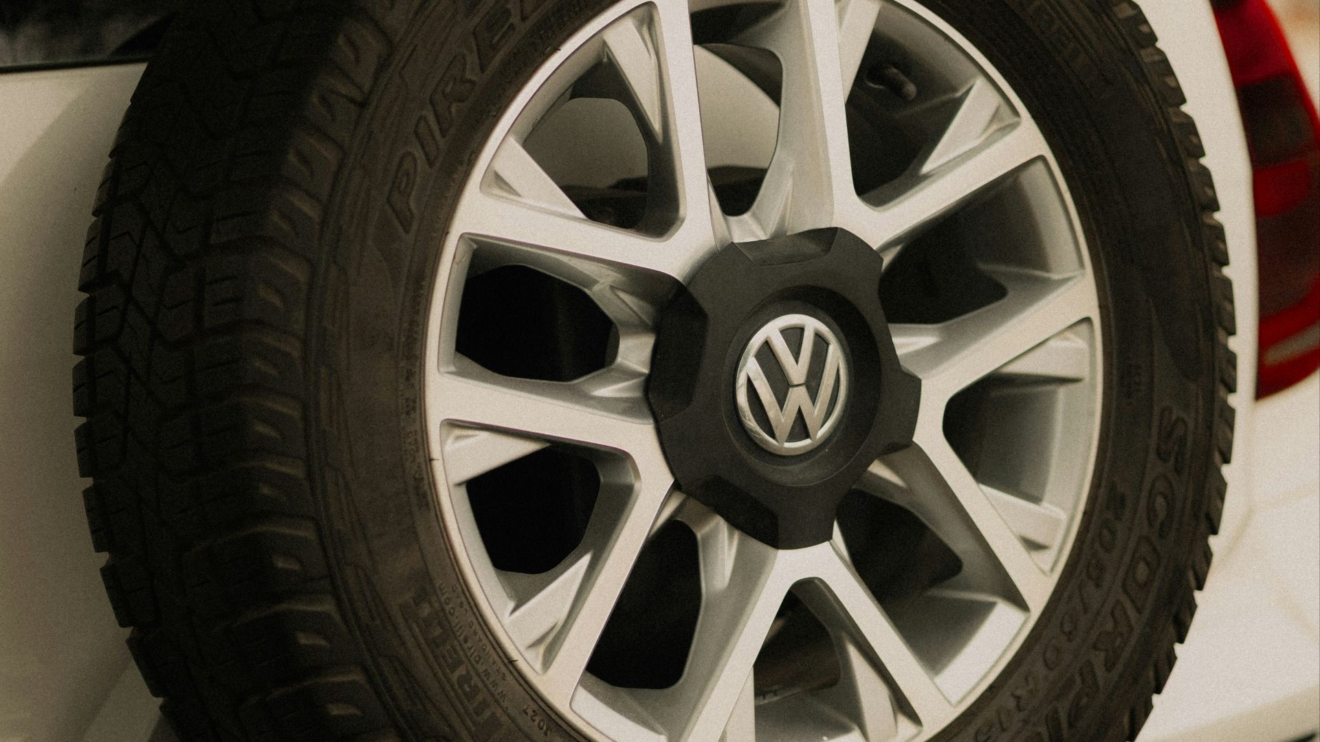 Spare tire mounted on the back of a white car.