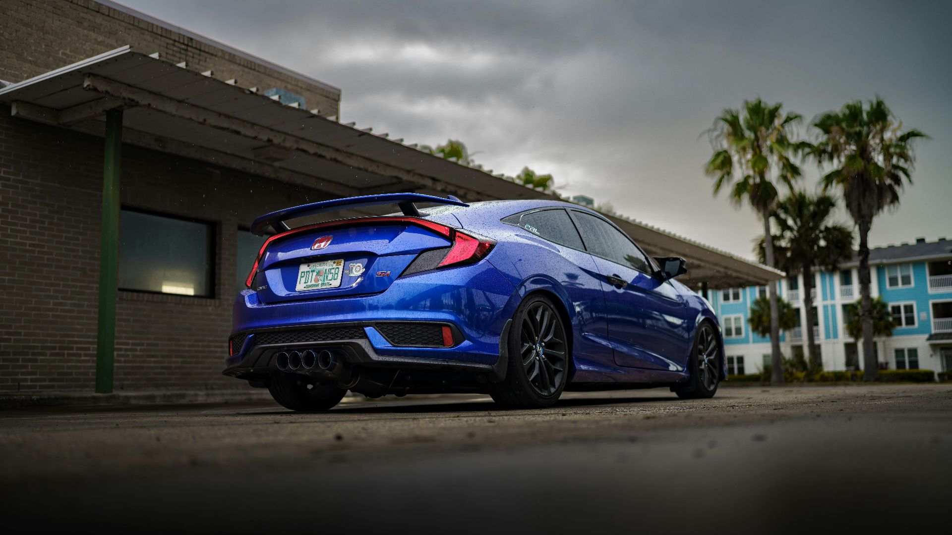 a blue car parked outside a building