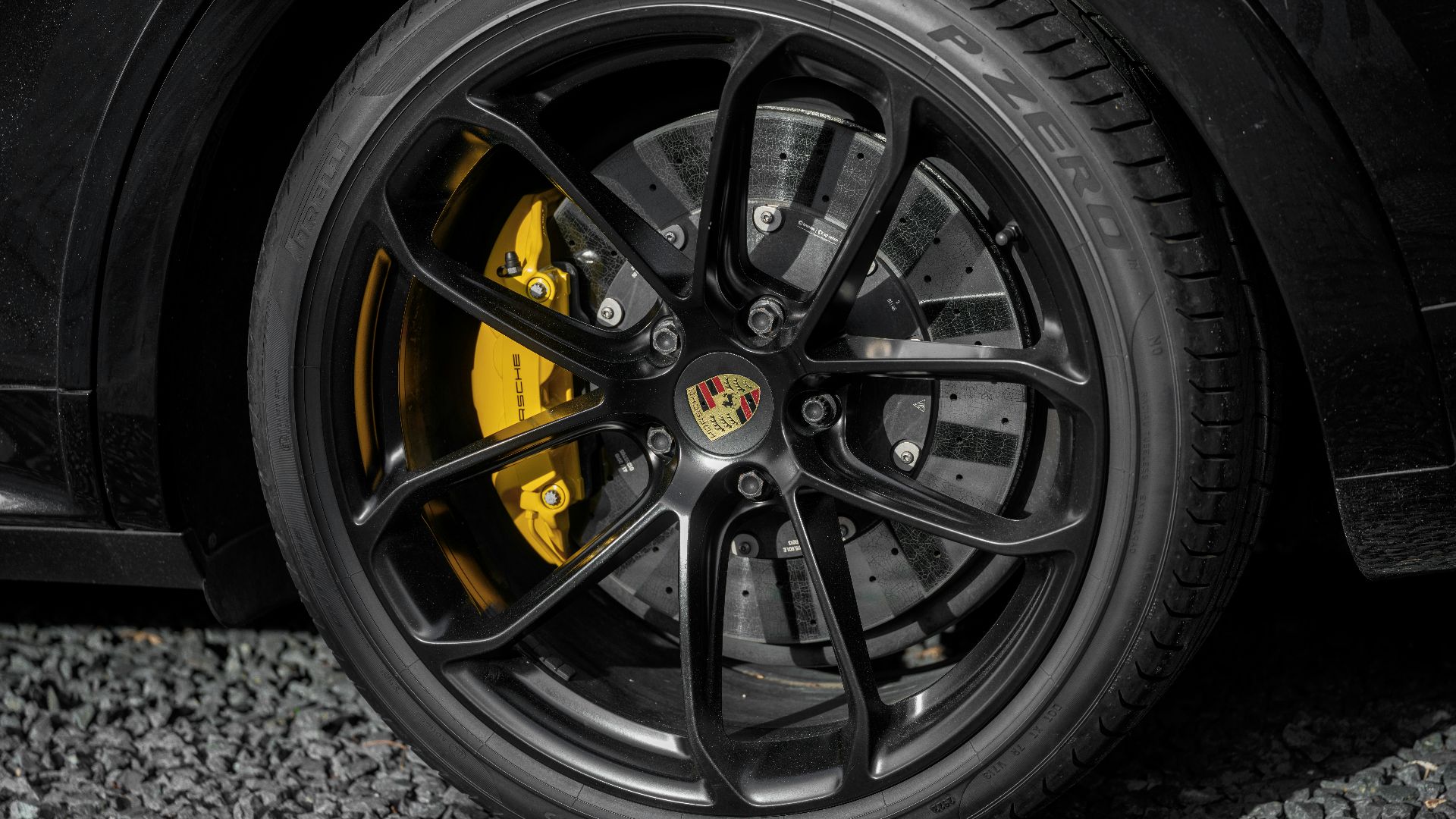 A close-up of a porsche car wheel.