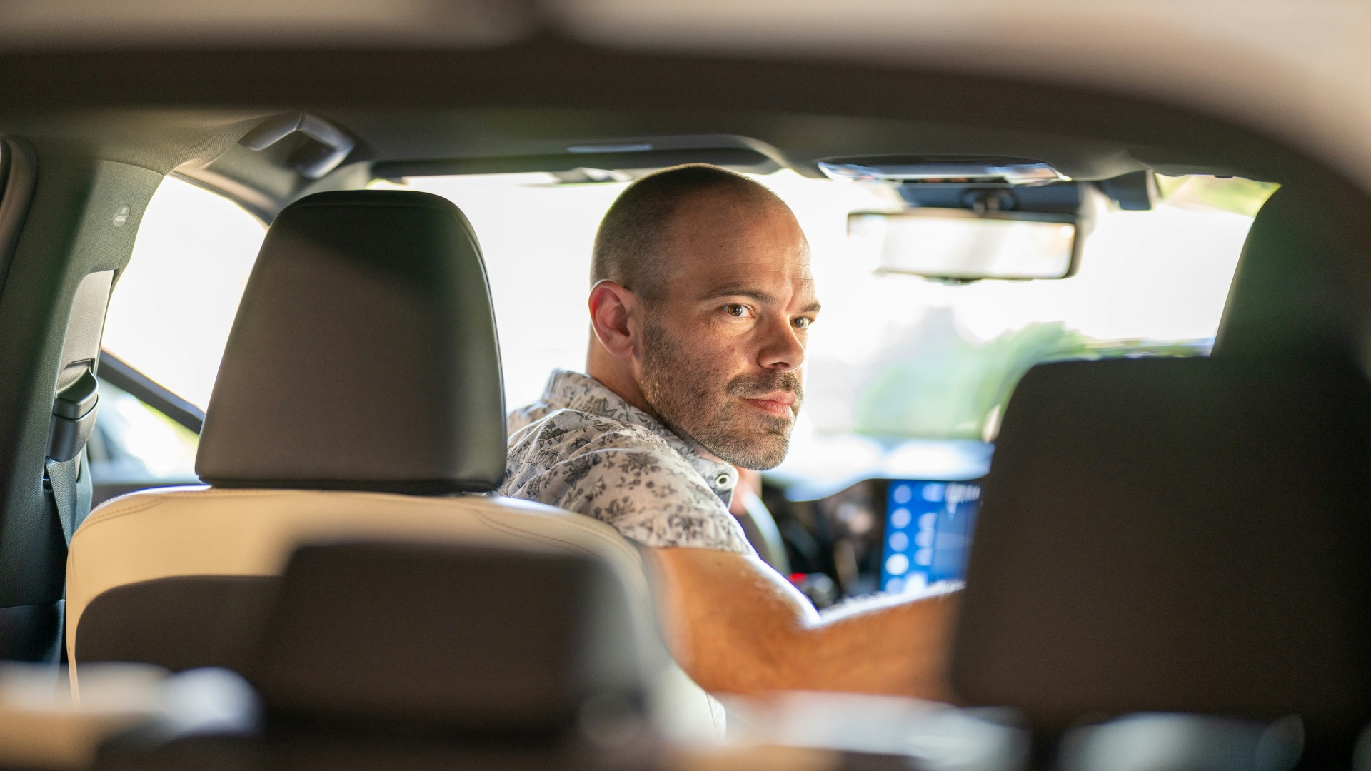 a man sitting in the passenger seat of a car