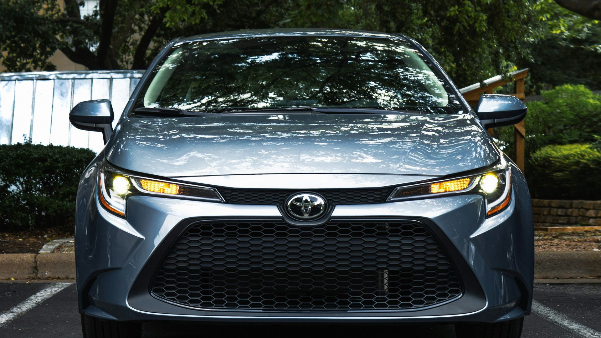 black mercedes benz car parked near green trees during daytime