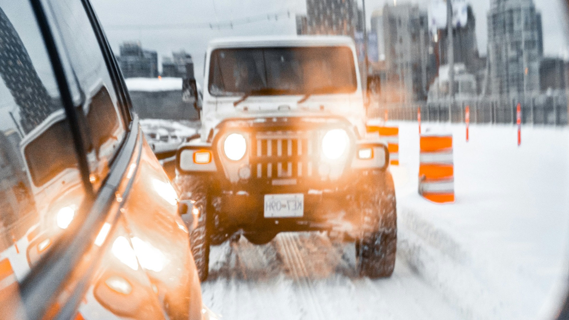 yellow car on road covered with snow during daytime