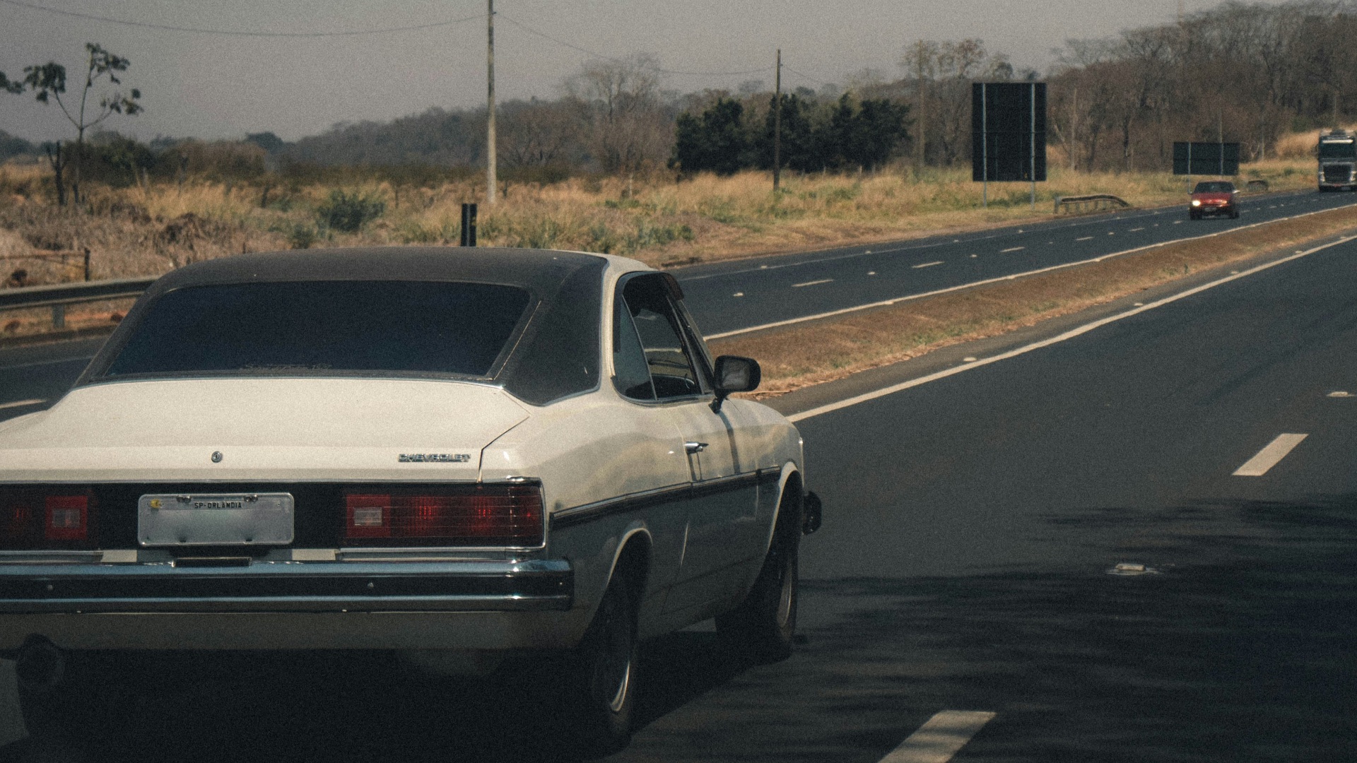 white sedan on road during daytime