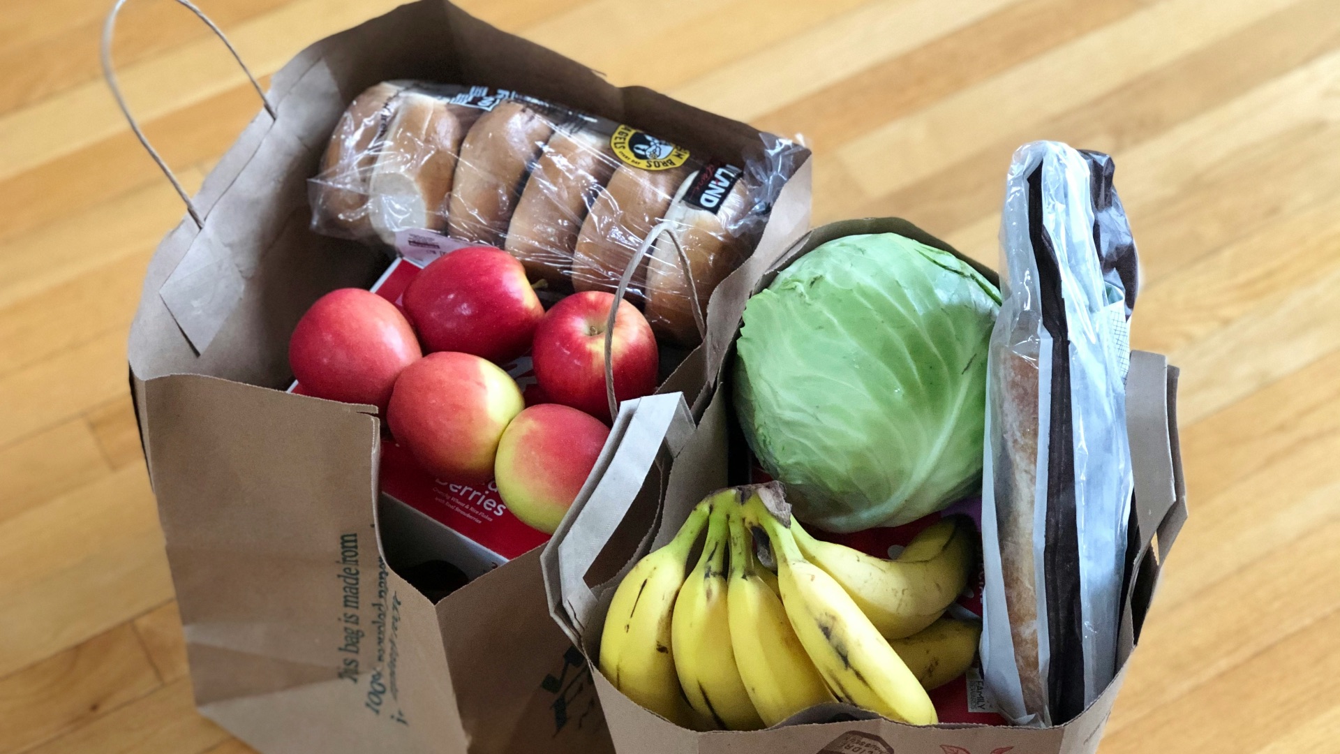 apples and bananas in brown cardboard box