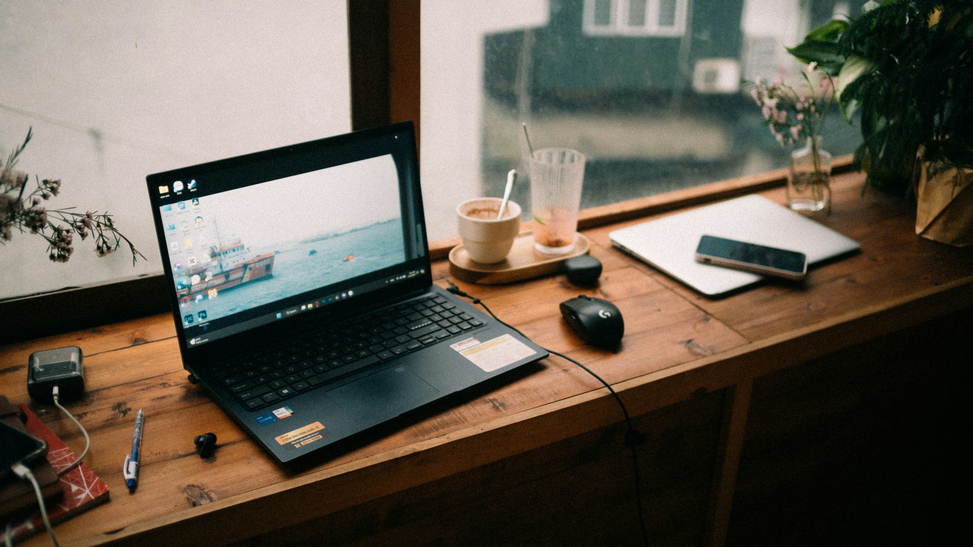 A laptop computer sitting on top of a wooden desk