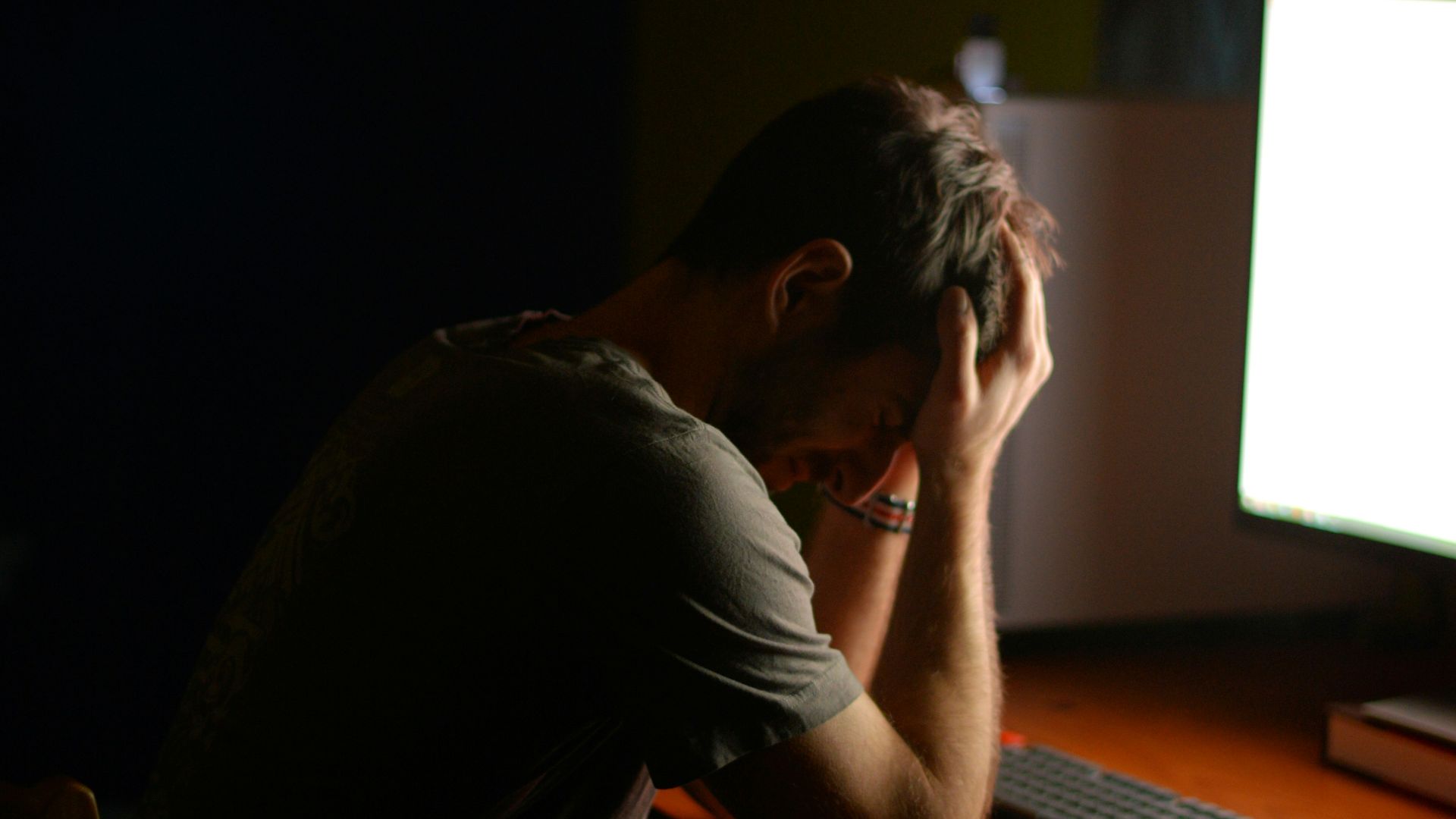 a man sitting at a desk in front of a computer