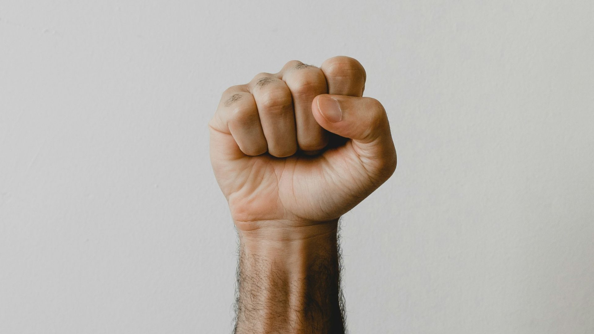 persons right foot on white wall