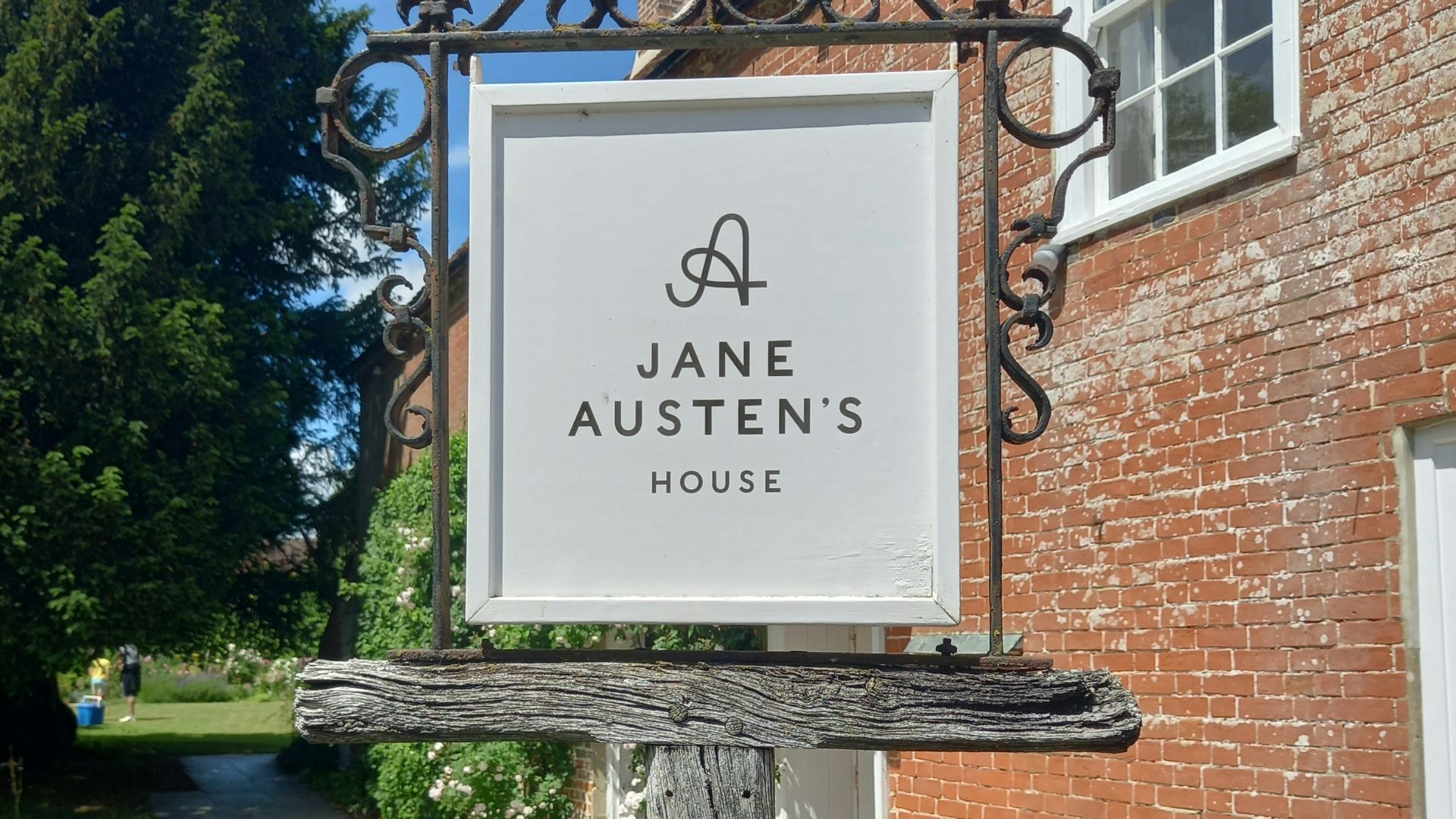 a sign in front of a brick building
