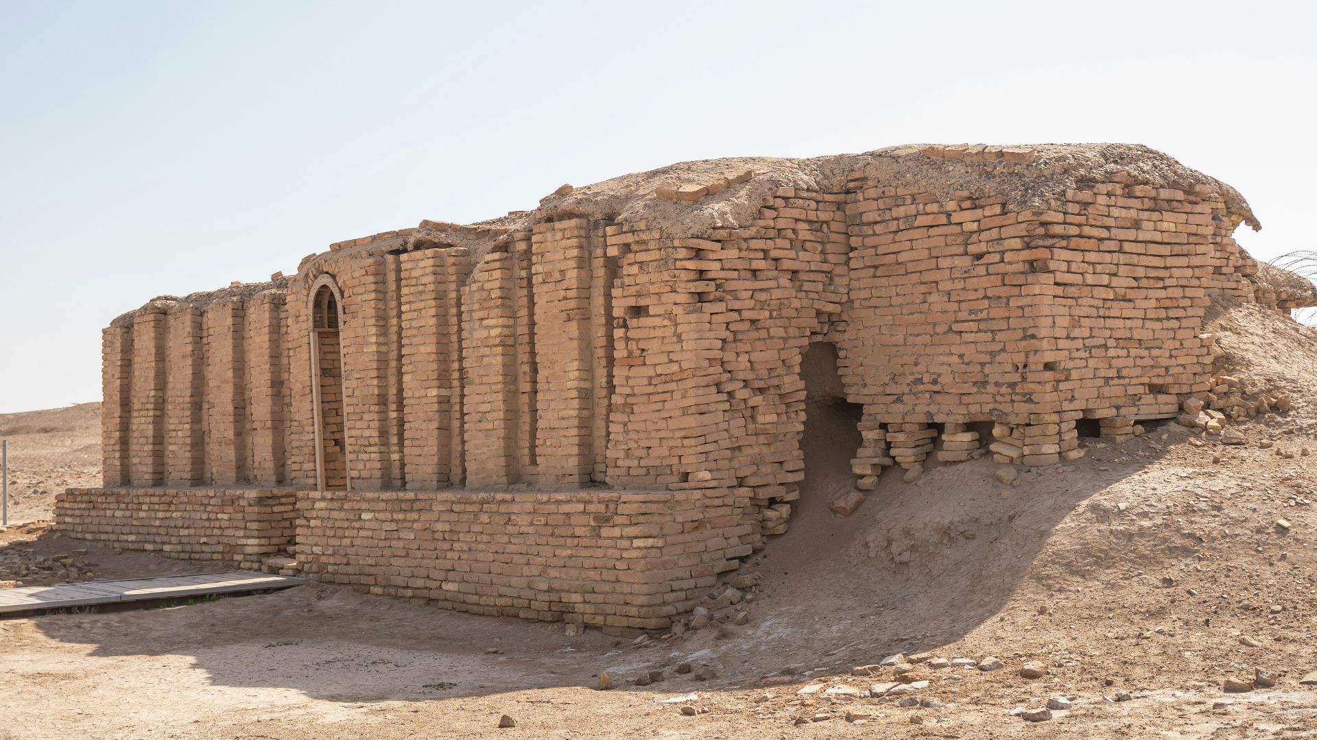 a large brick structure sitting in the middle of a desert