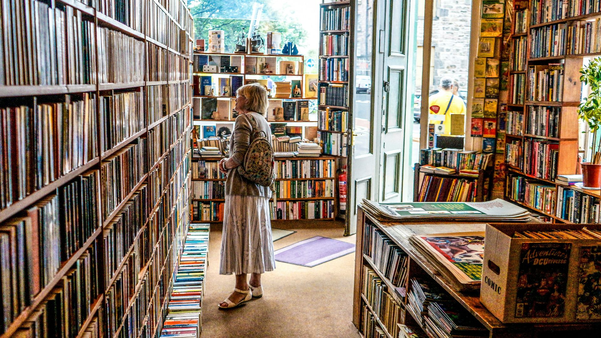 woman inside library looking at books