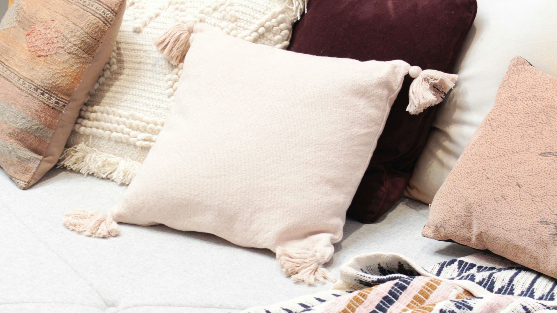 assorted throw pillows on gray couch
