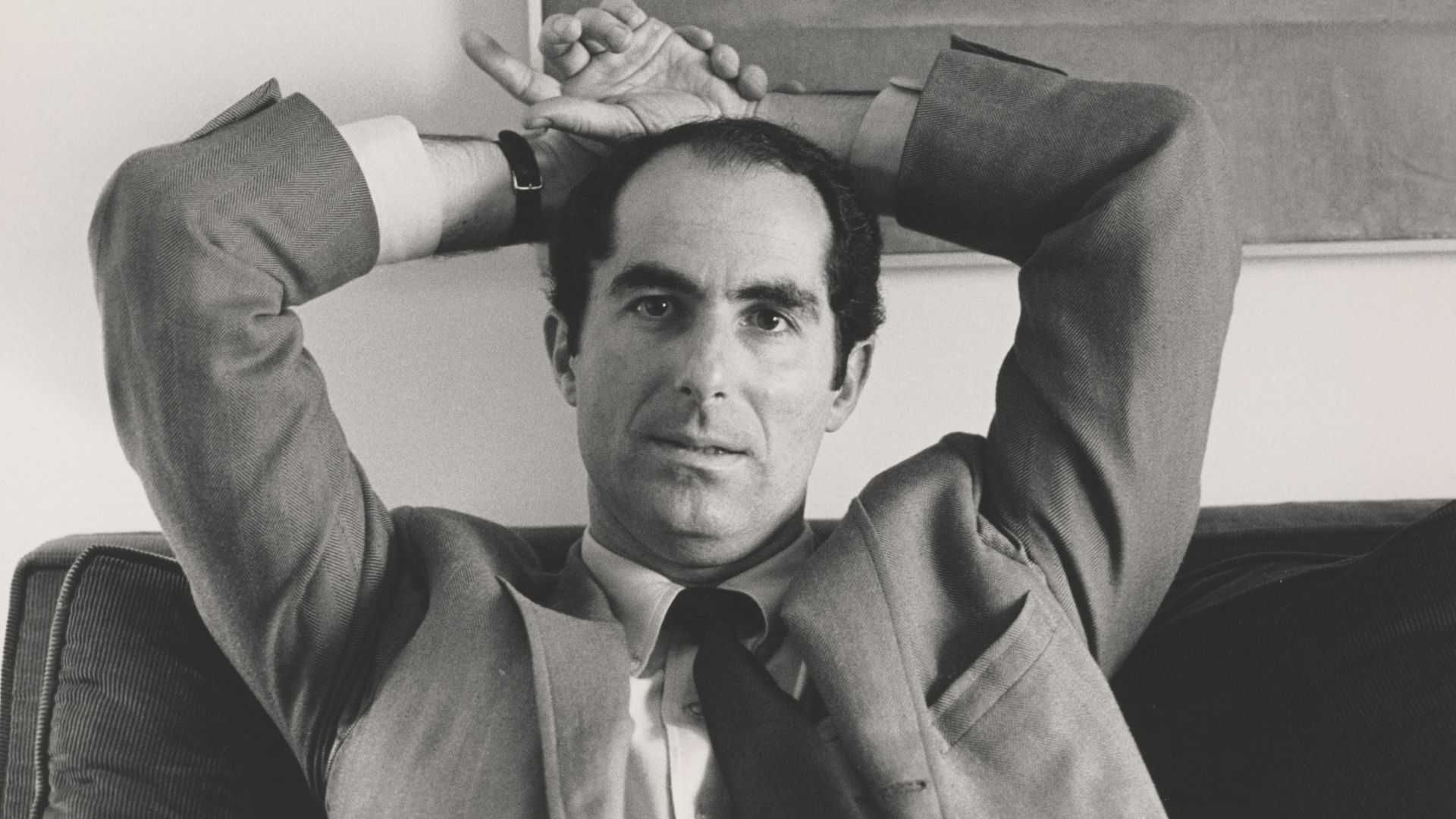 File:Philip Roth, seated, hands behind head.jpg