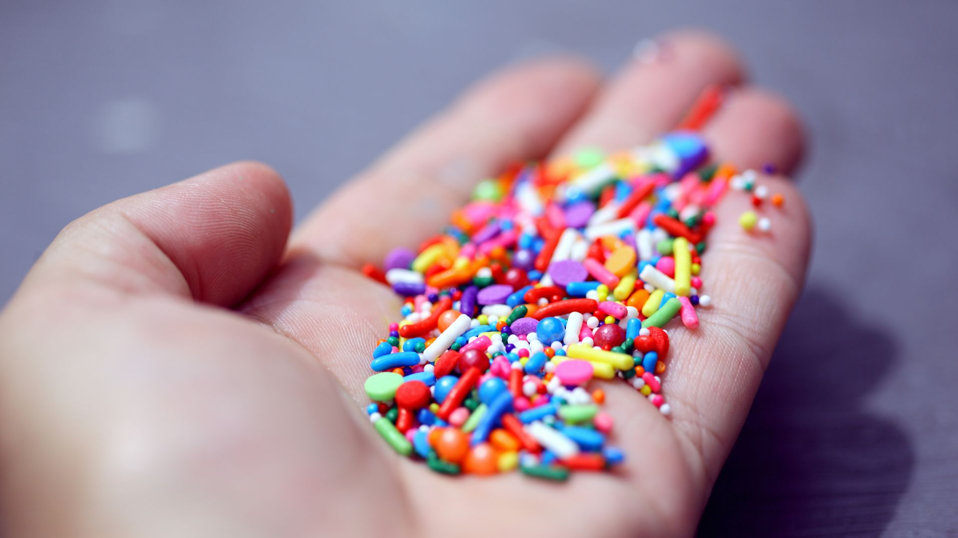 person holding multi colored beaded bracelet