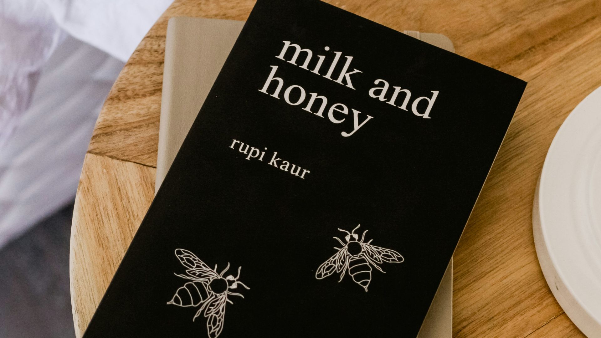 Milk and Honey by Rupi Kaur book on side table