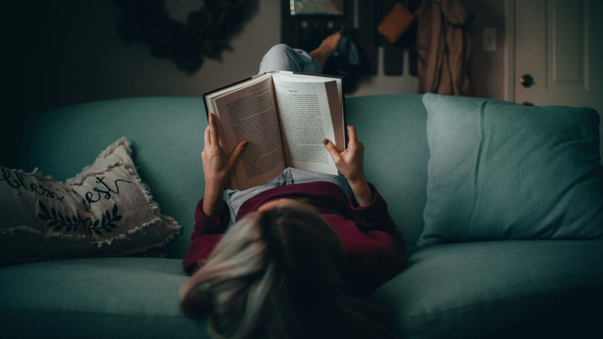 woman in red shirt reading book