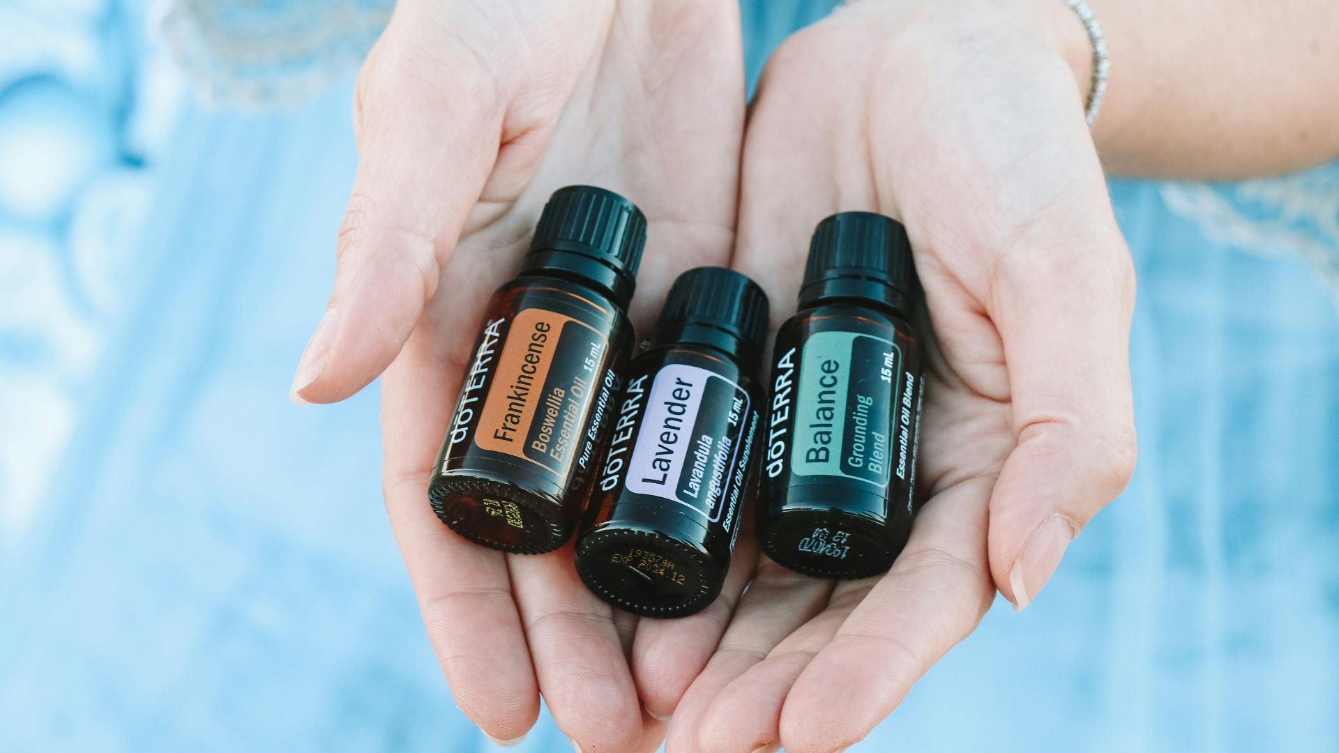 two black bottles on persons hand