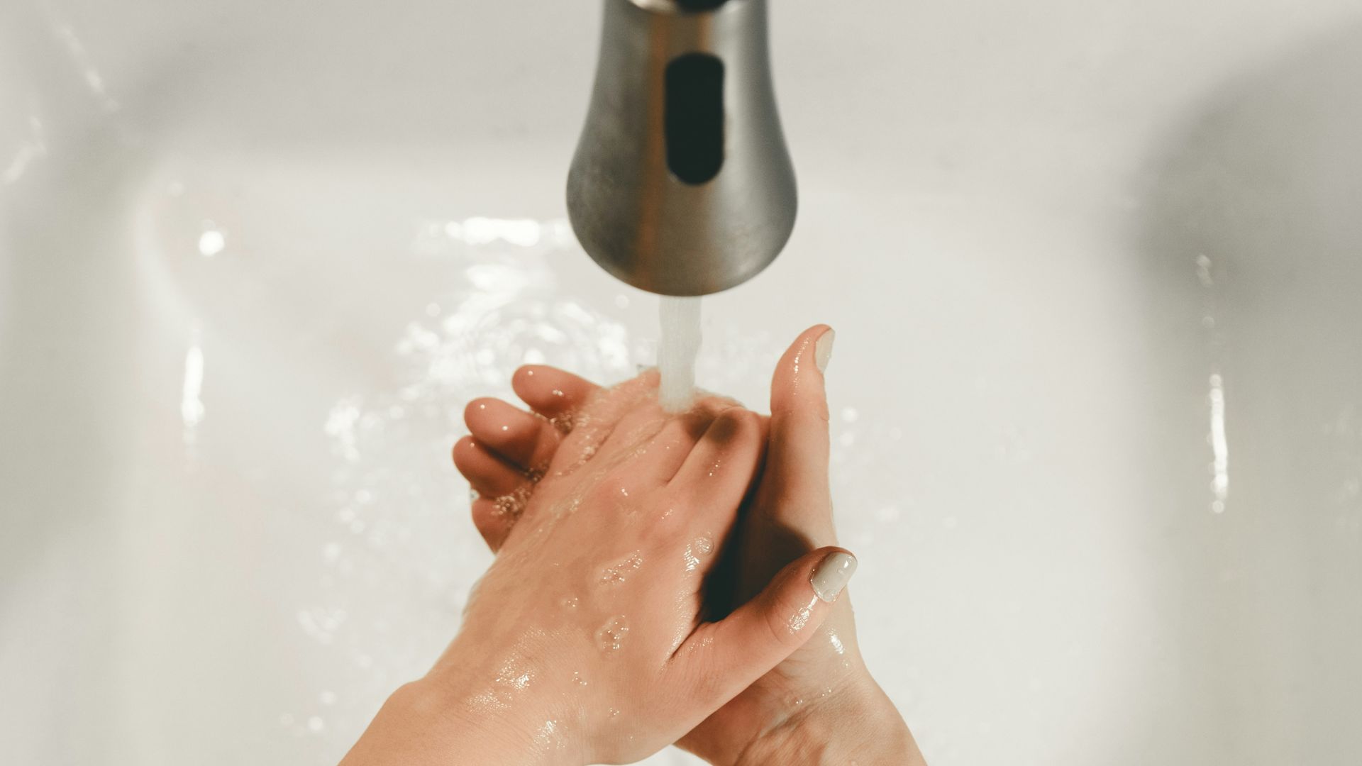persons feet on white bathtub