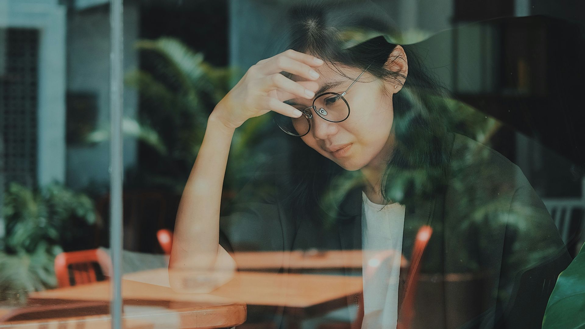 woman touching her forehead