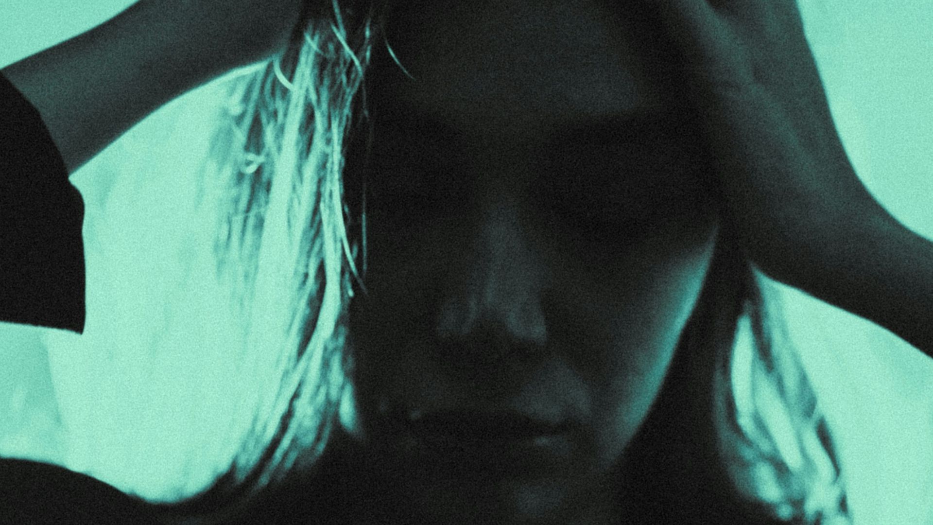 a woman holding her hair in the dark