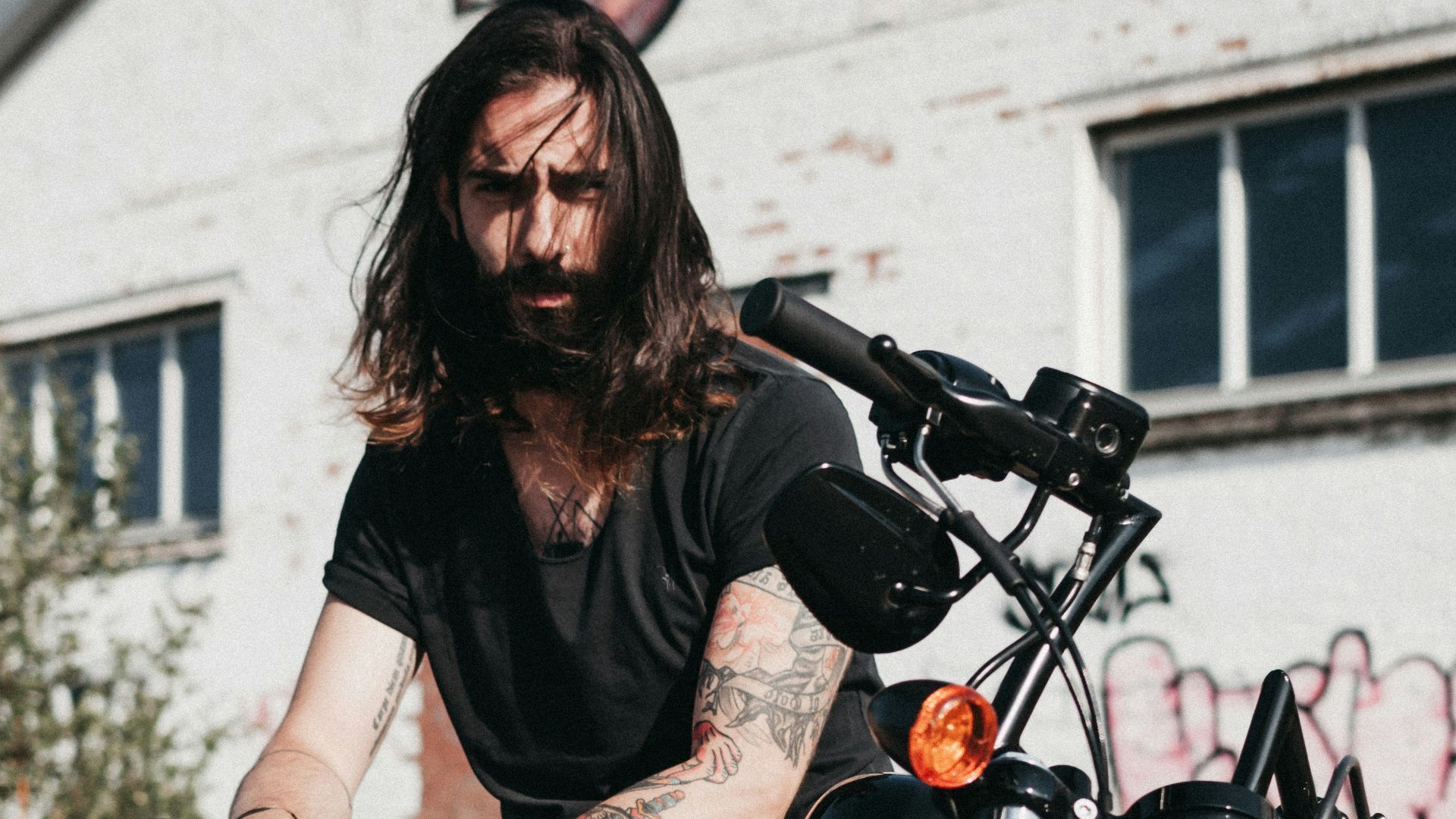 man sitting on black cruiser motorcycle