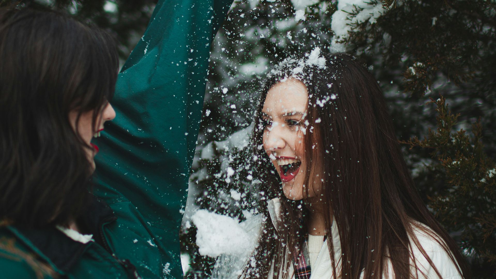 woman in green jacket standing near green tree during daytime