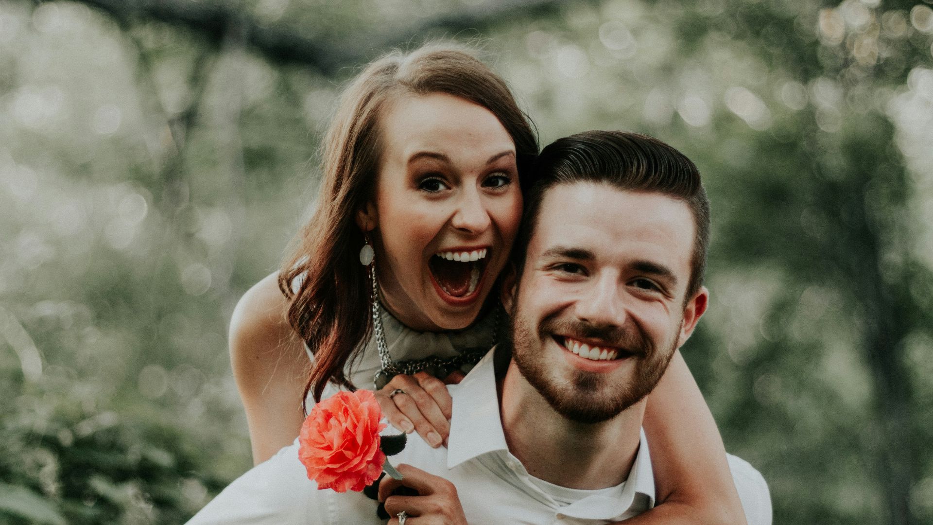 woman riding on back of man