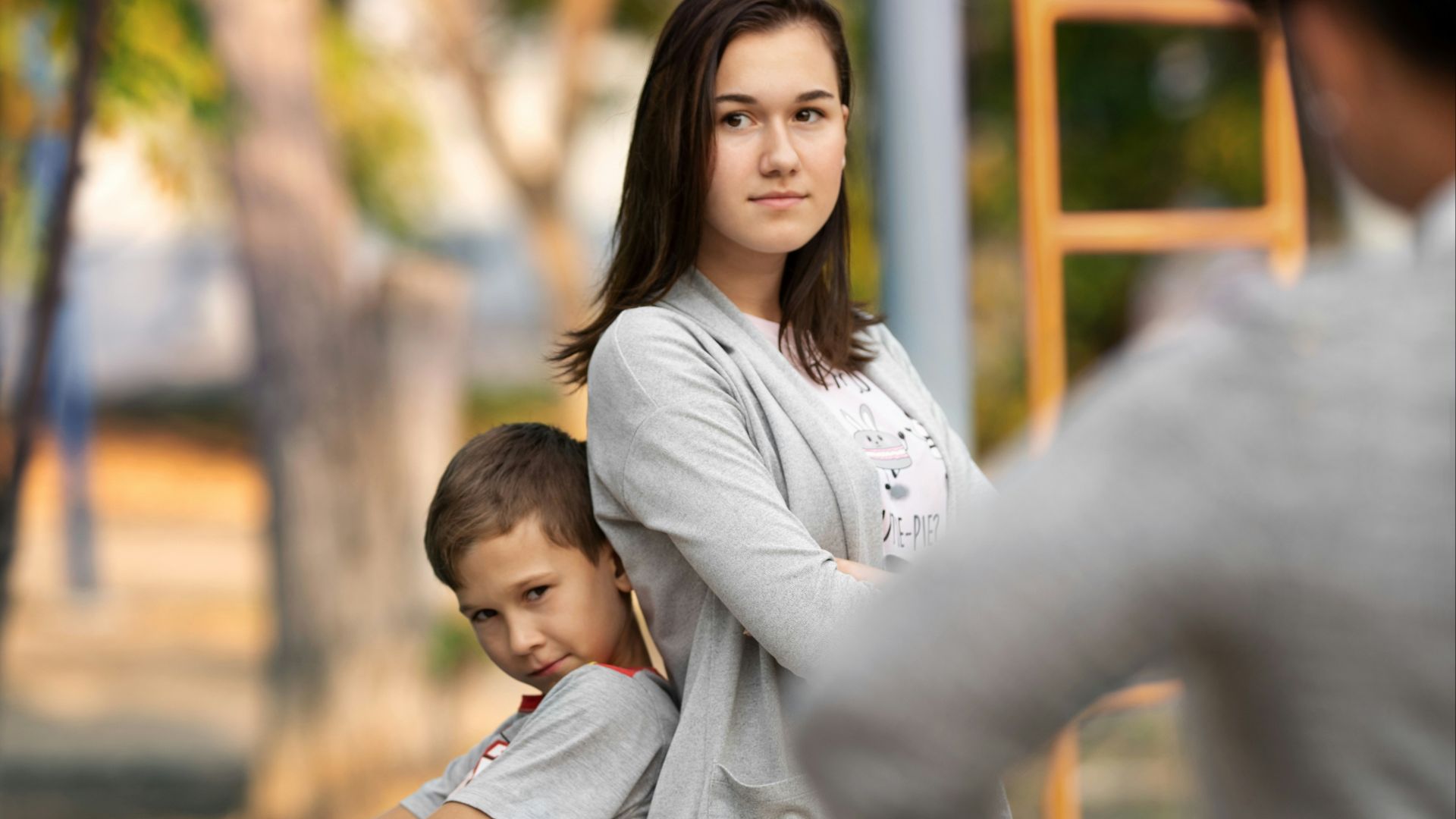 woman in white long sleeve shirt carrying child in white long sleeve shirt