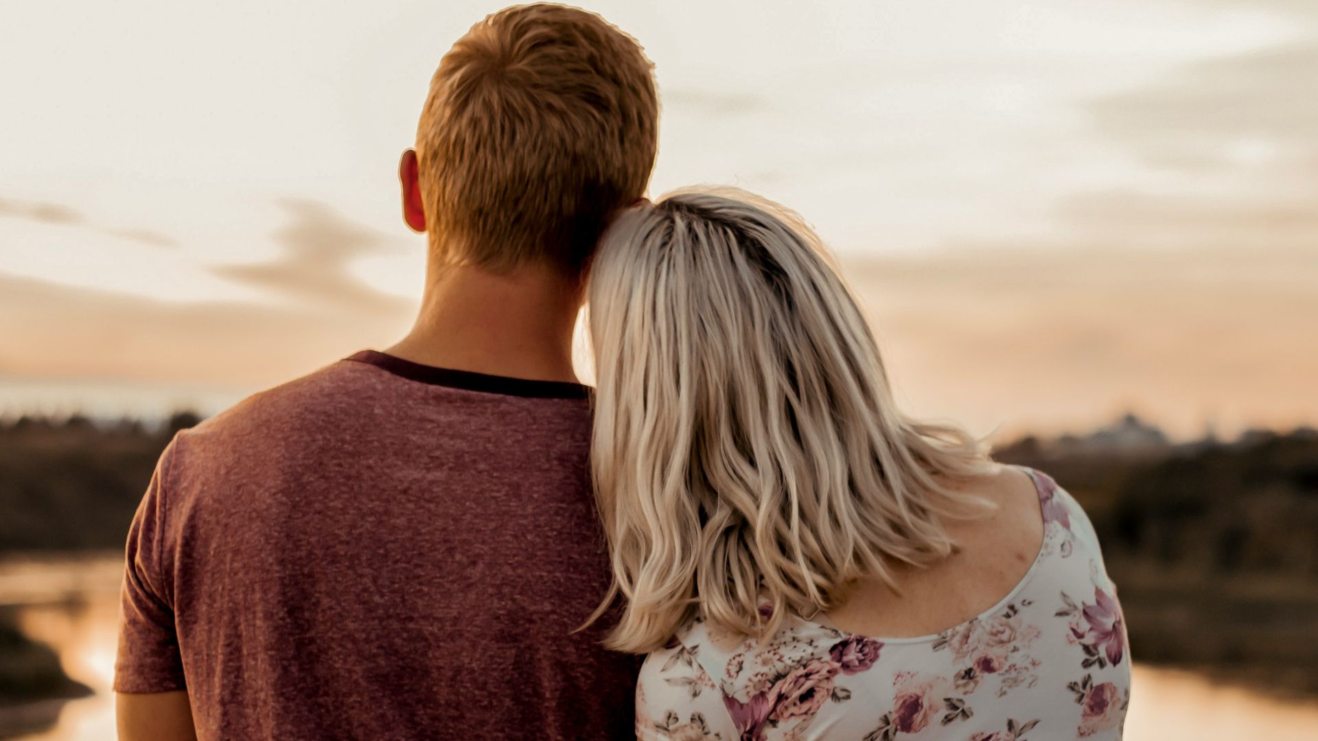 man and woman standing on brown field during daytime