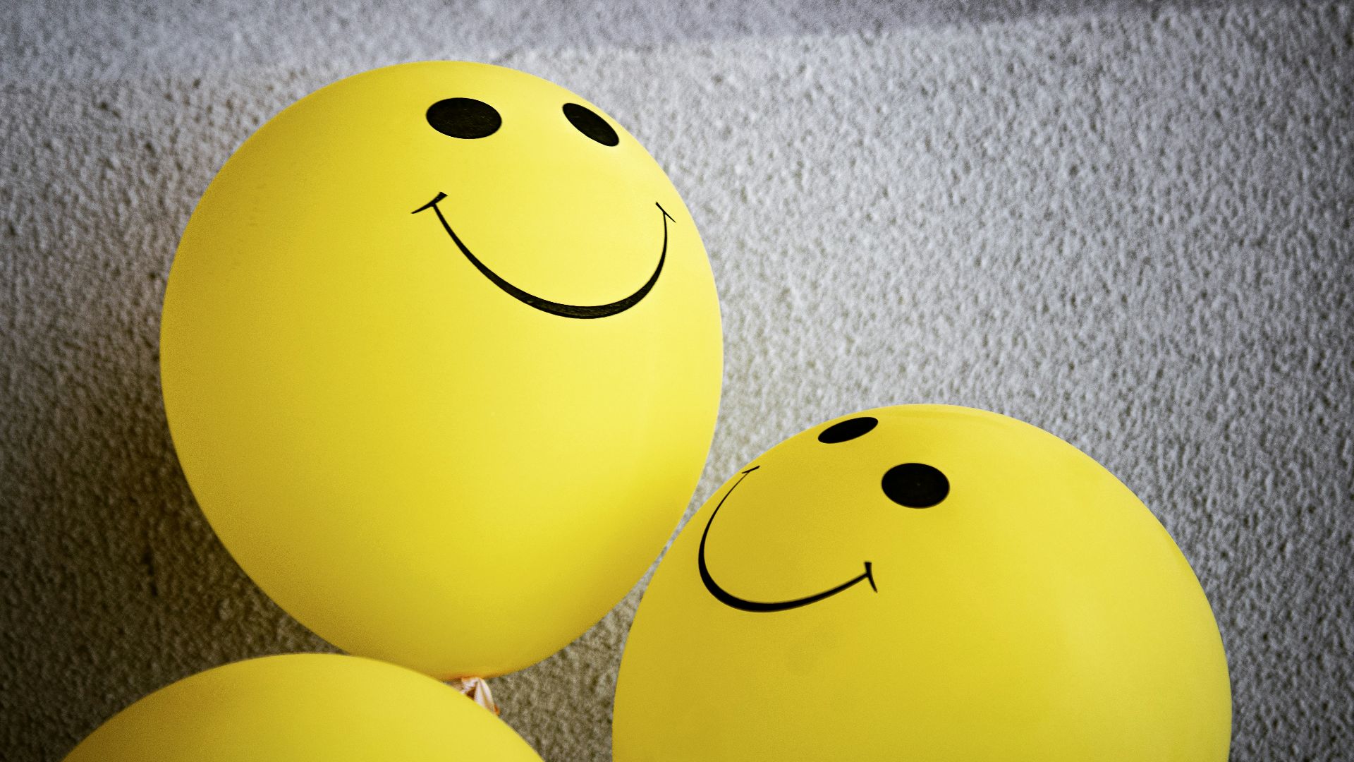 yellow smiley emoji on gray textile