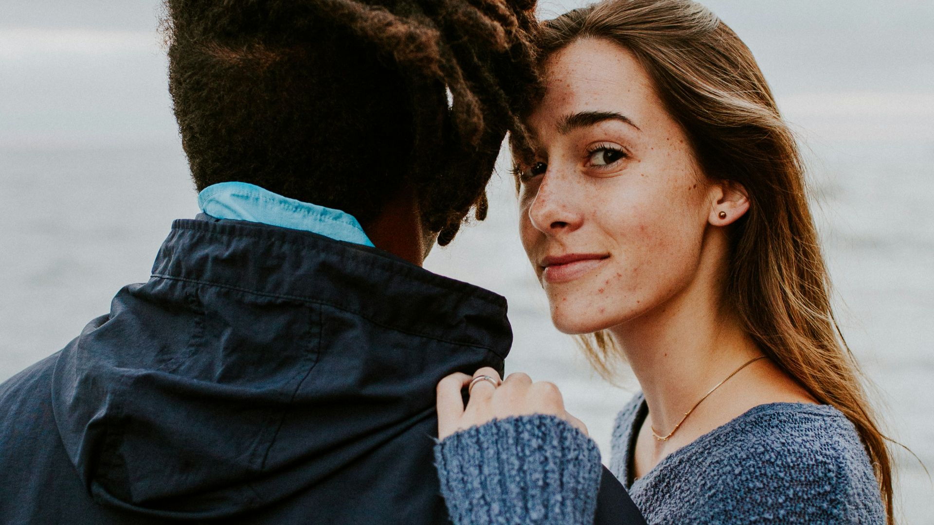 woman in blue long sleeve shirt beside woman in gray long sleeve shirt