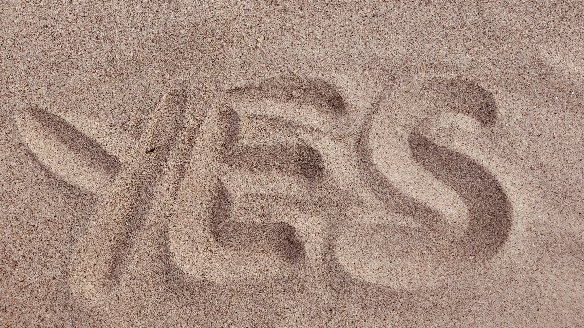 yes text on brown sand