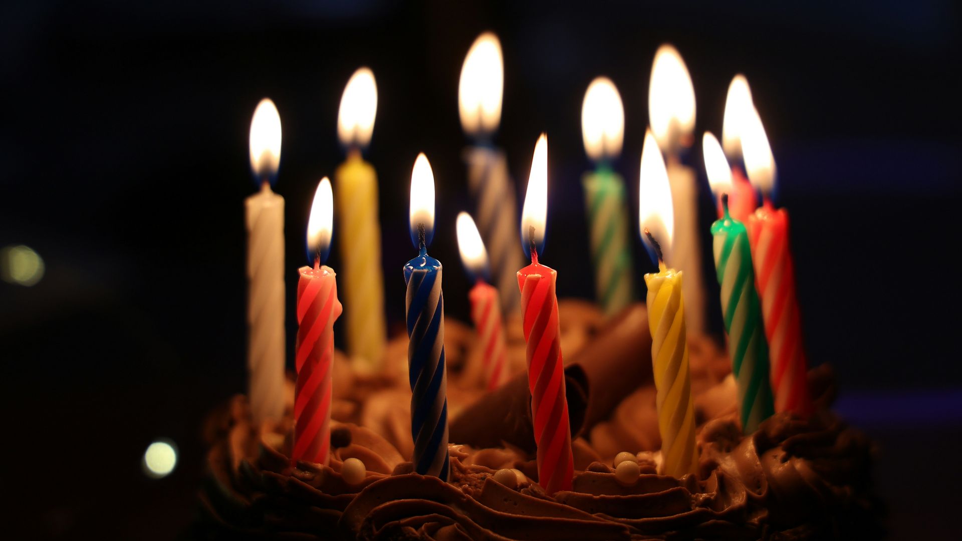 lighted candles on brown cake