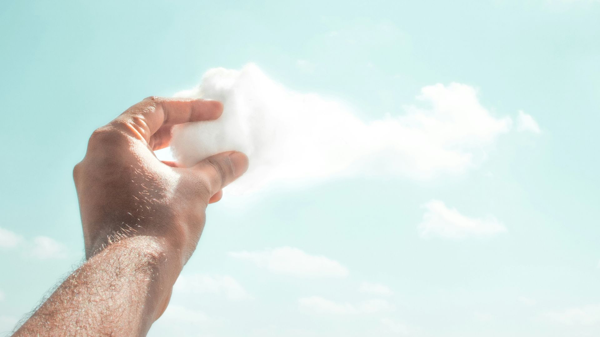 person holding white cotton candy