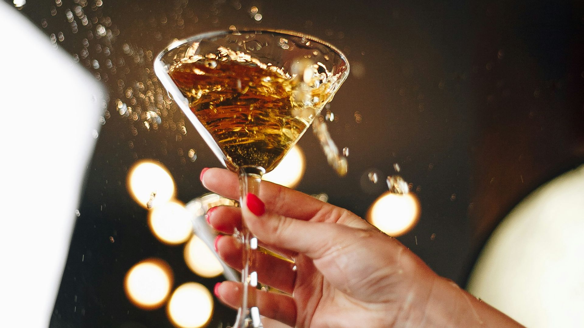 person holding clear wine glass