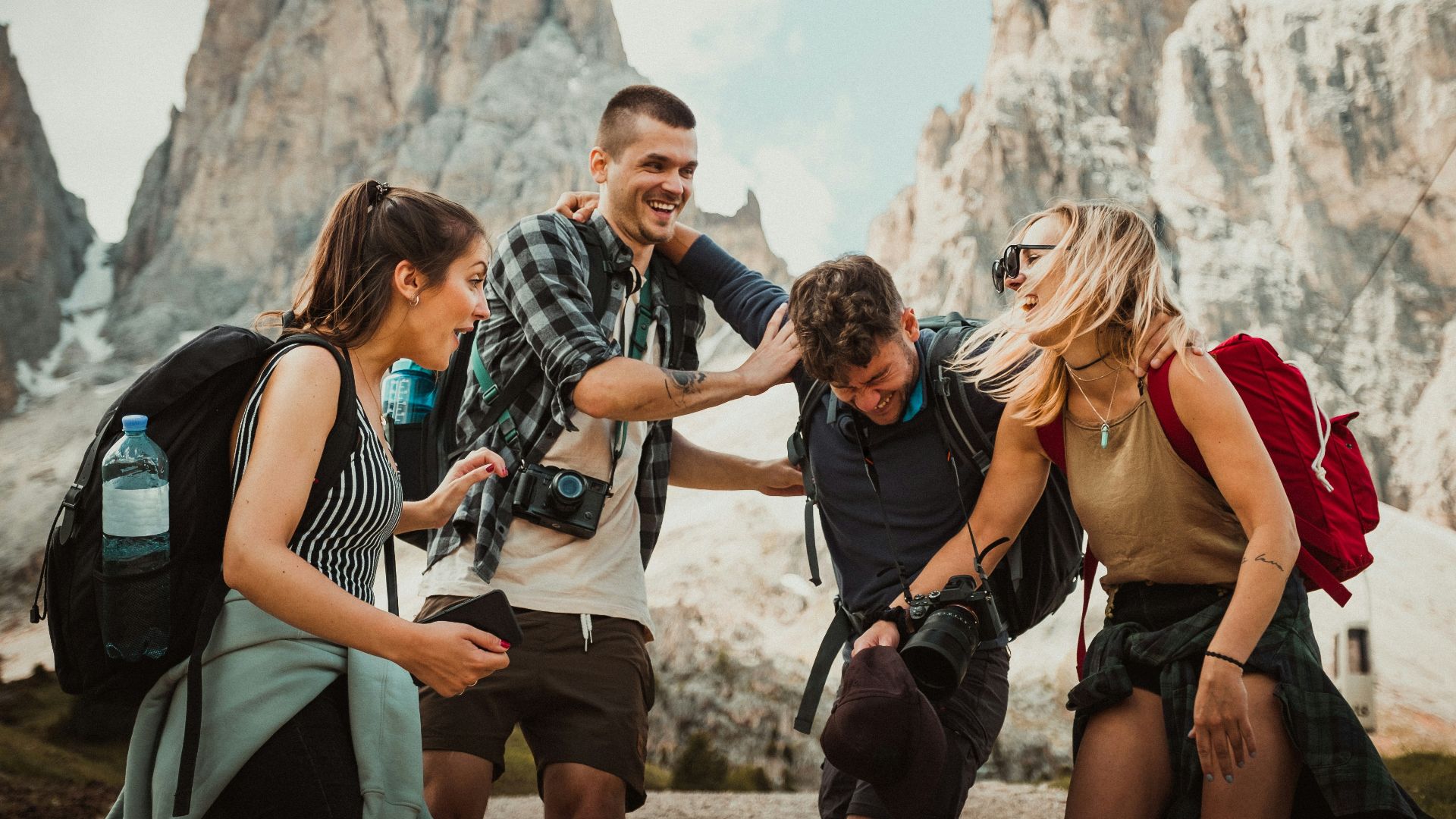 low-angle photography of two men playing beside two women