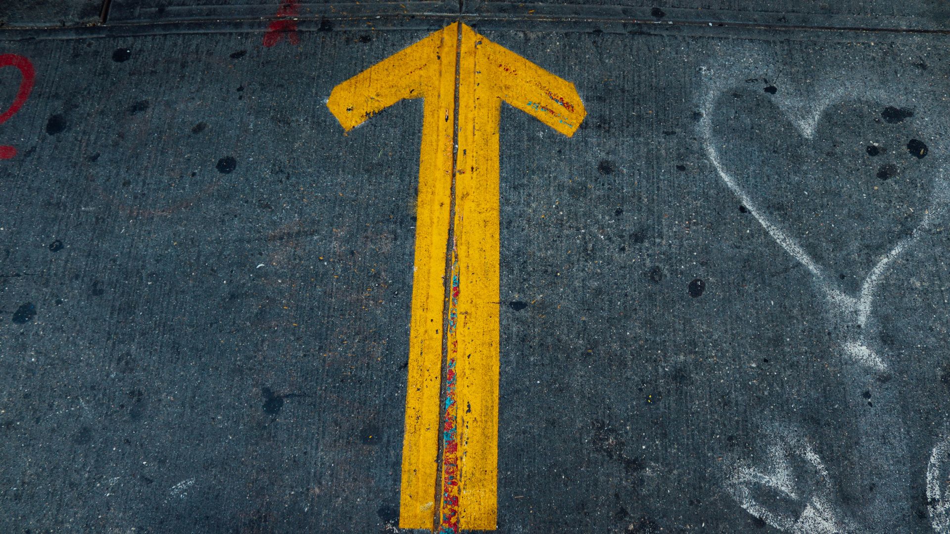 a yellow triangle on a road