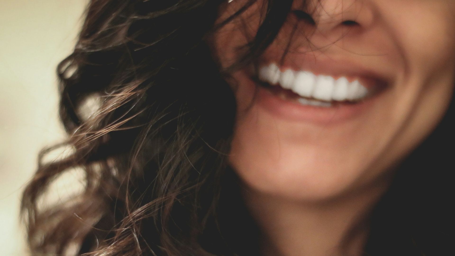 long black haired woman smiling close-up photography