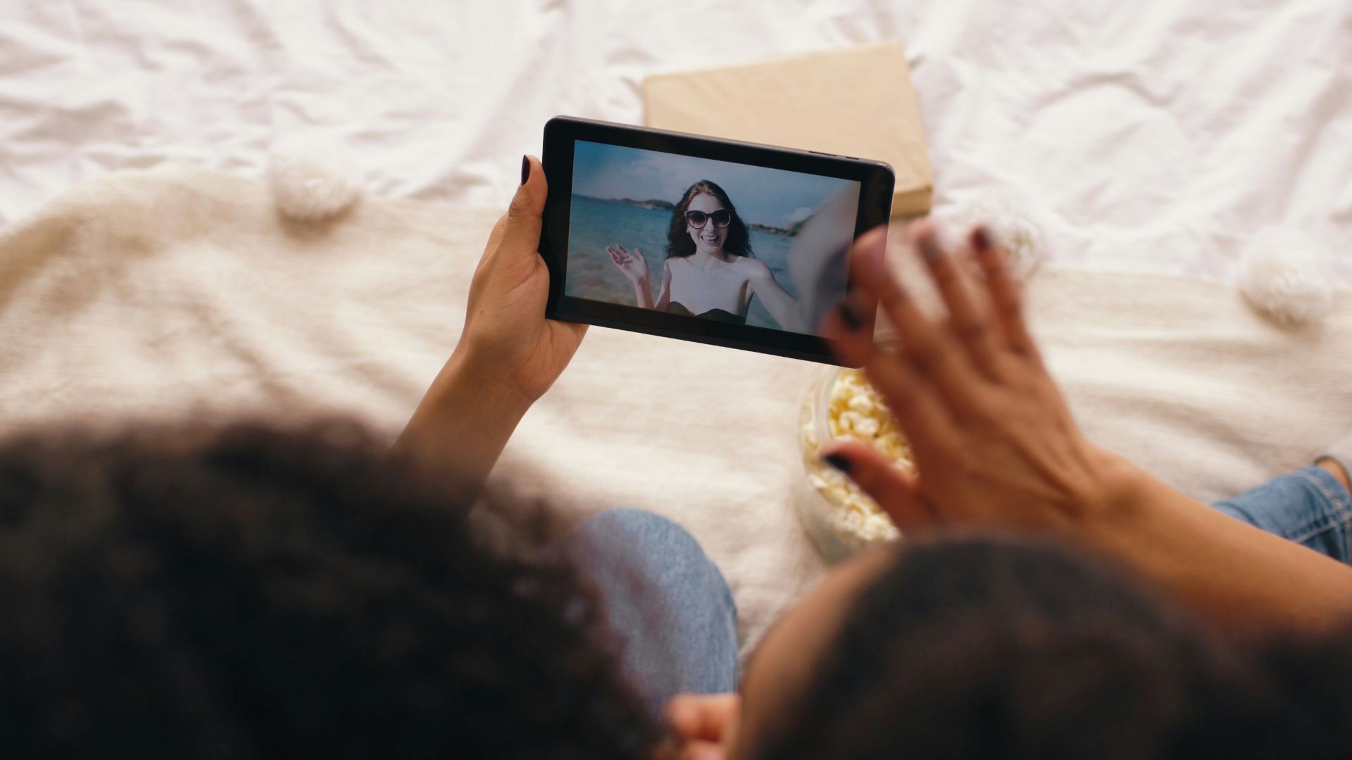 Two people video calling on a tablet