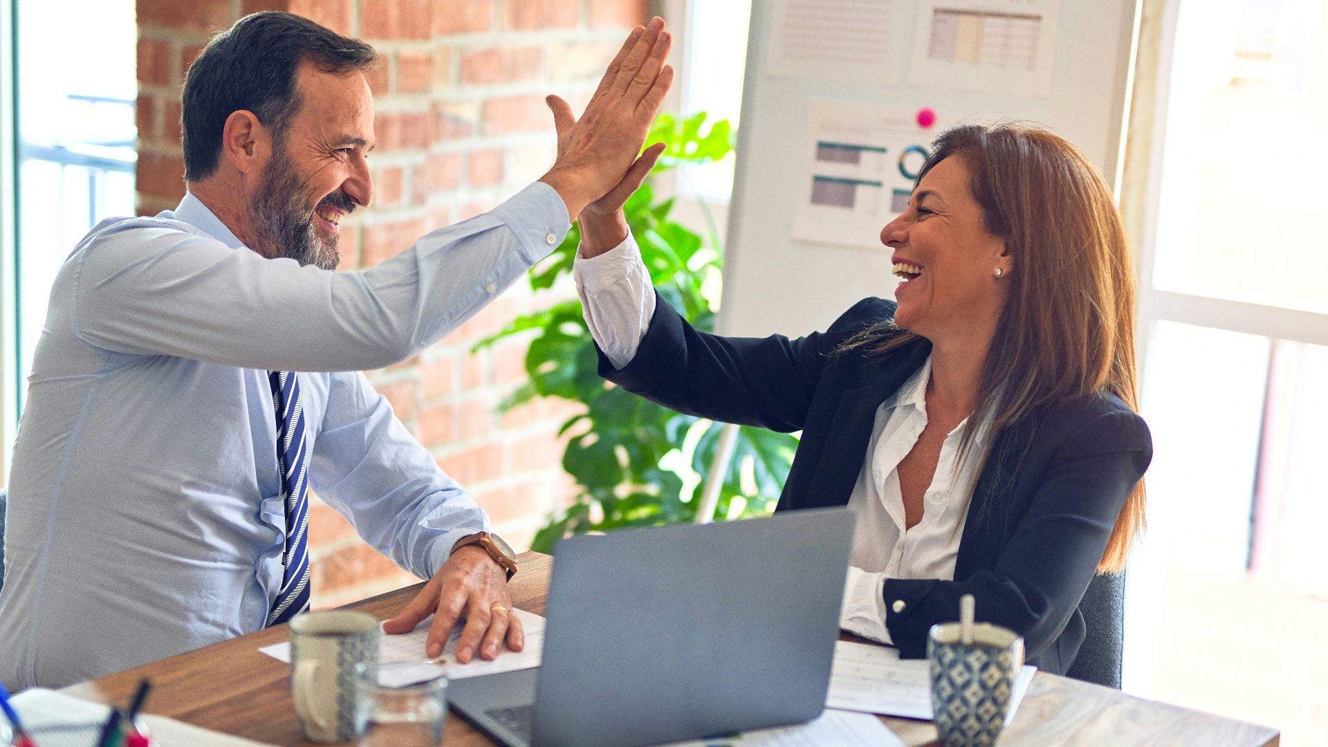 man in white dress shirt sitting beside woman in black long sleeve shirt