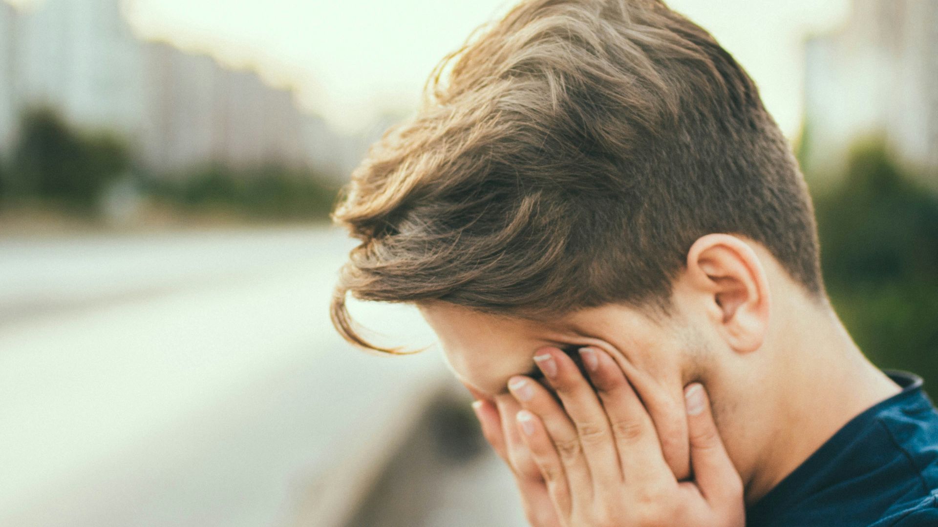 person covering own face