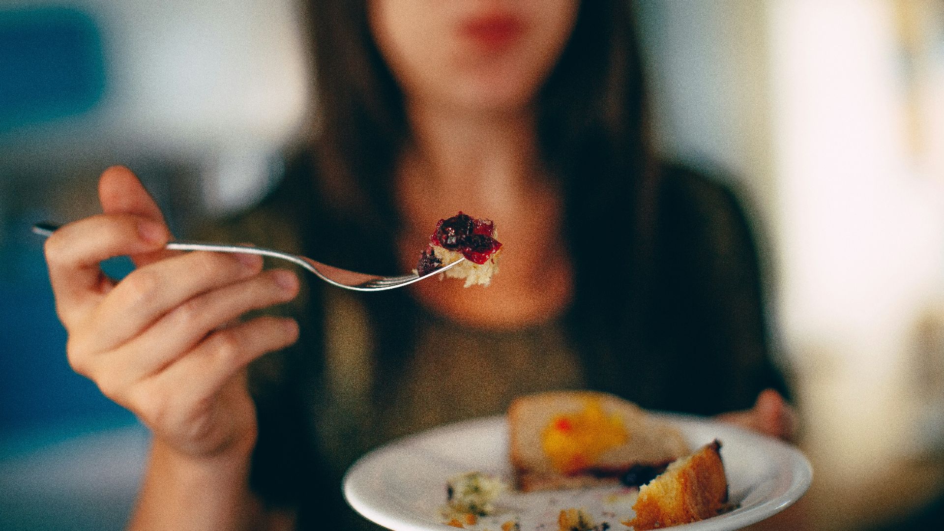 woman holding plate of cake