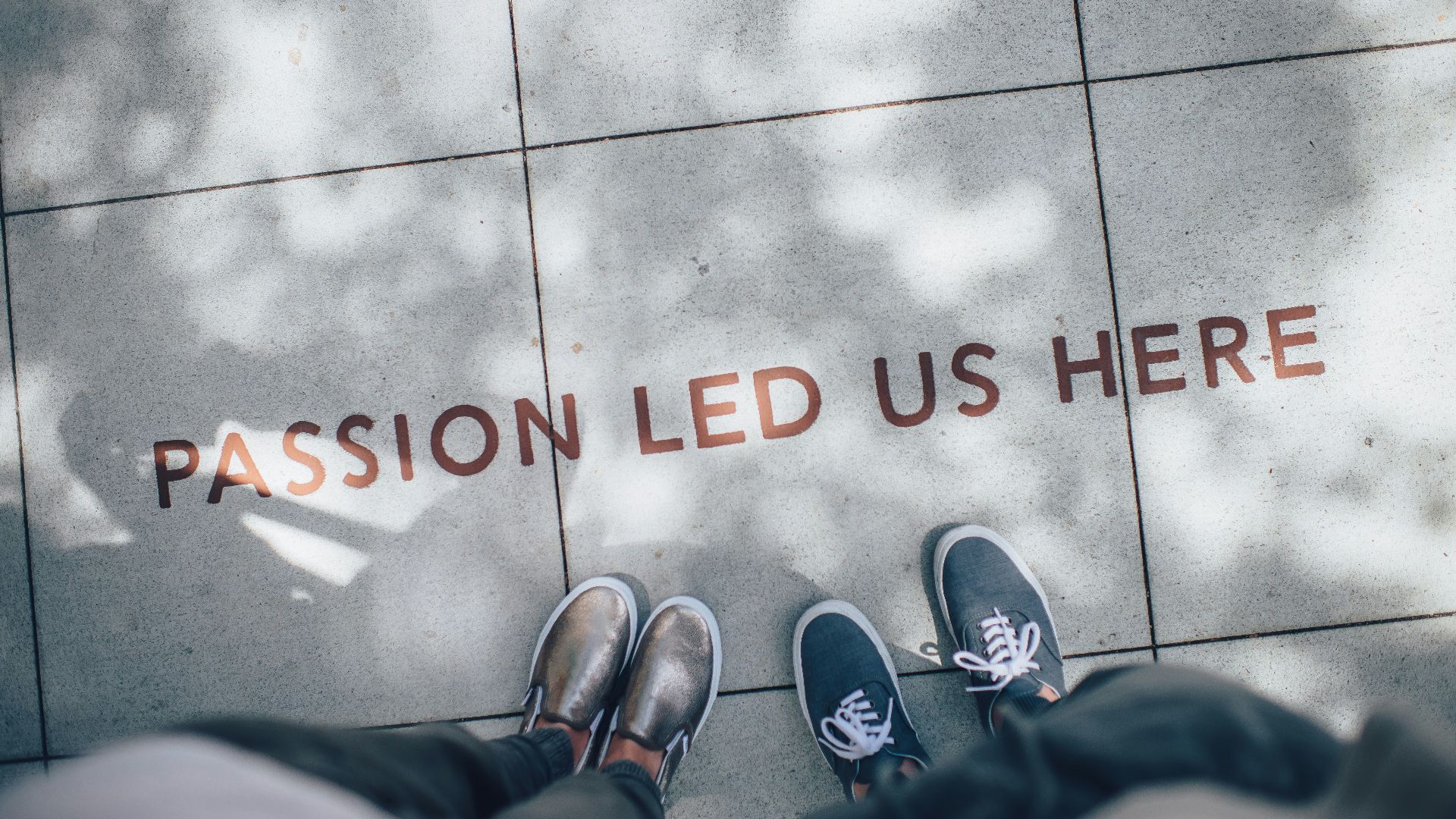 two person standing on gray tile paving