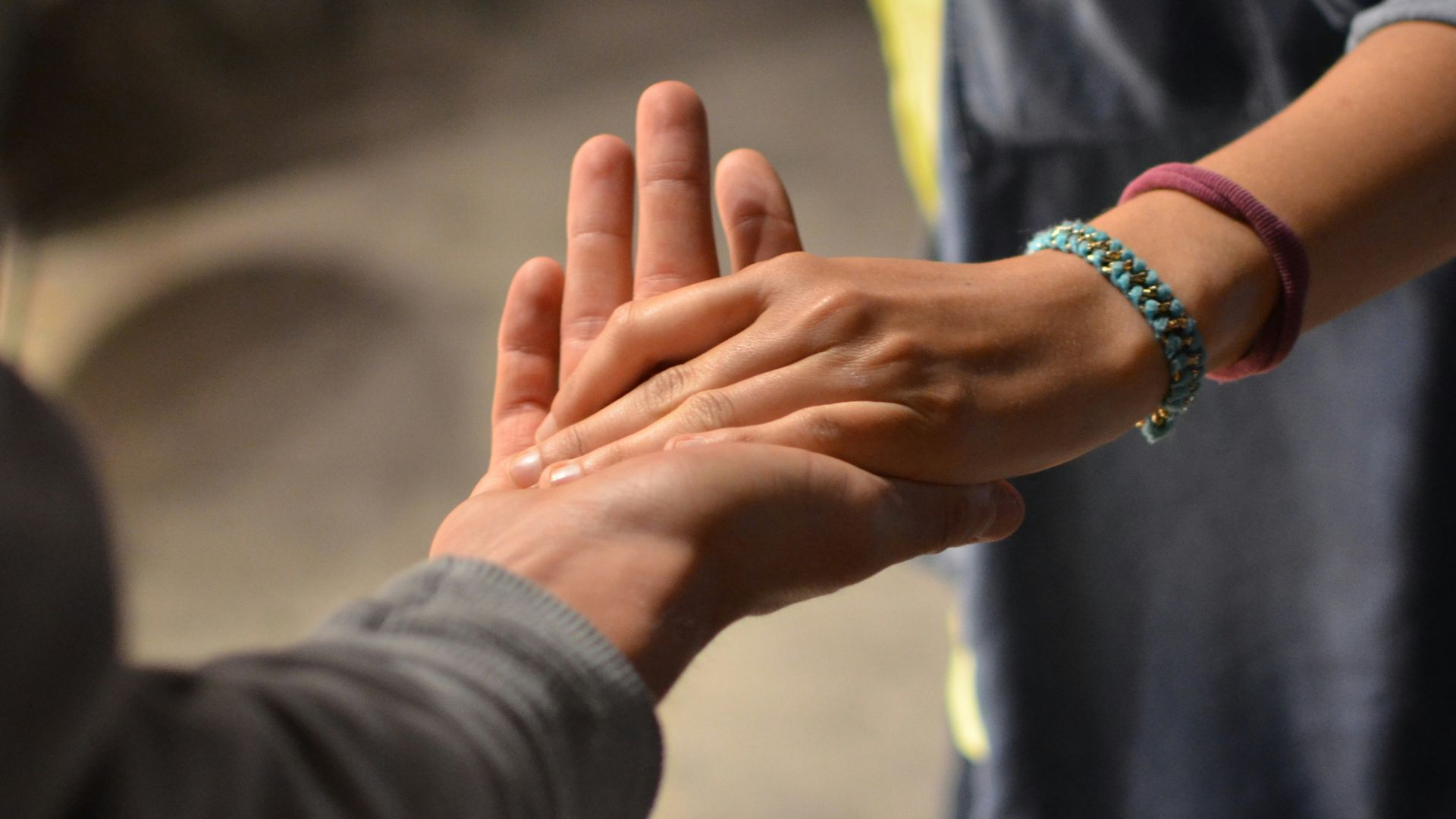 man and woman holding hands on street