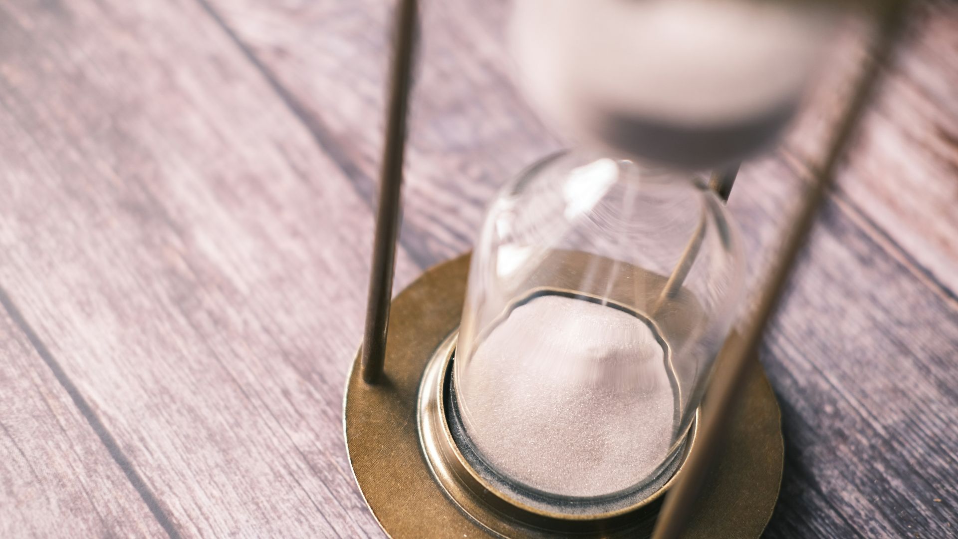 an hourglass sitting on top of a wooden table