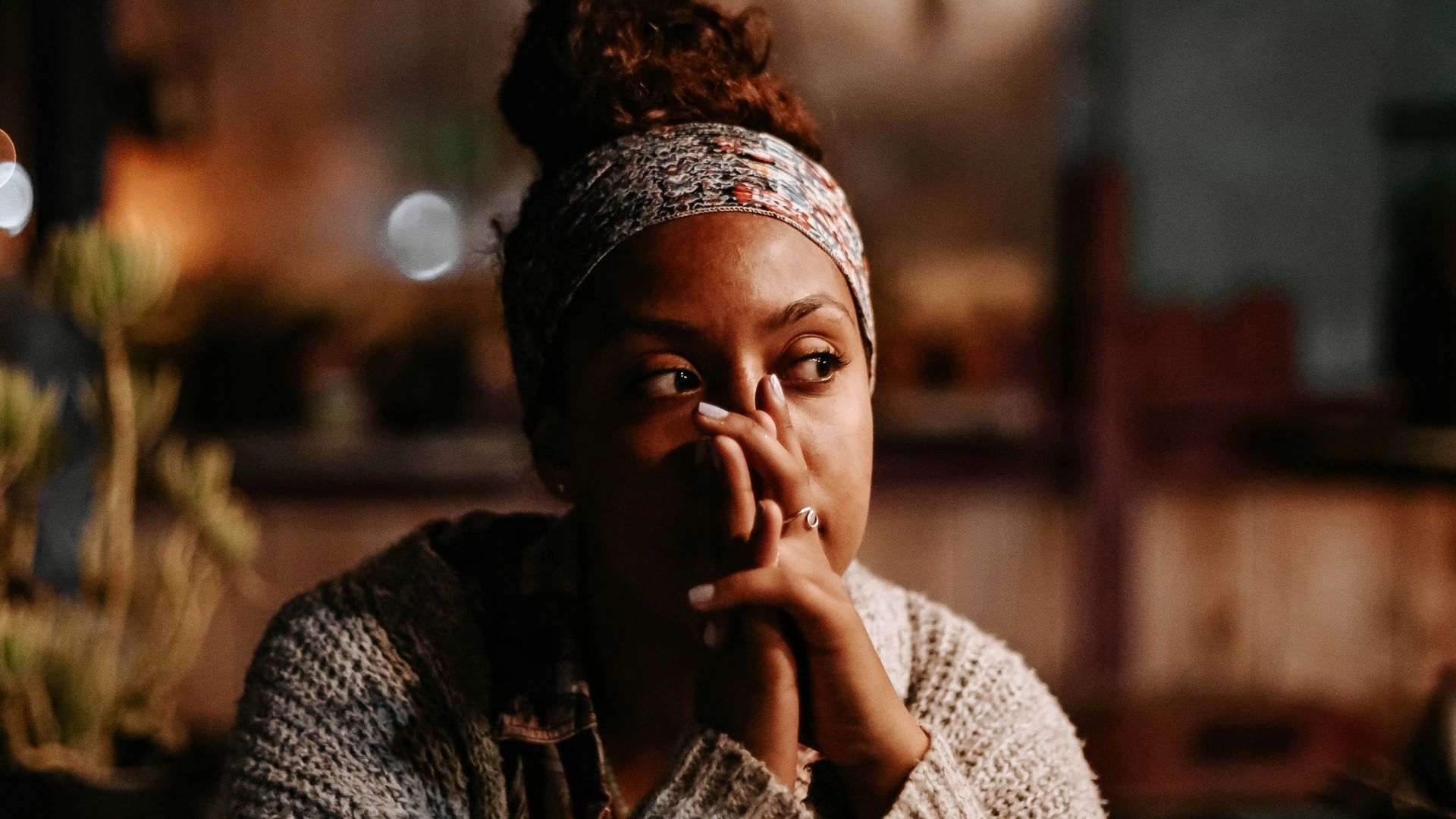 man in black and white sweater sitting on chair