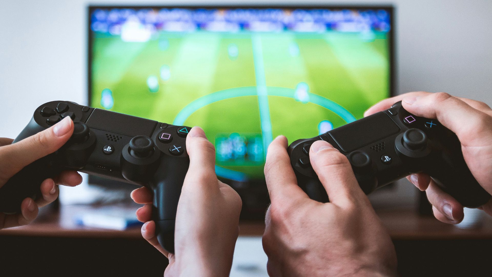 two people playing Sony PS4 game console