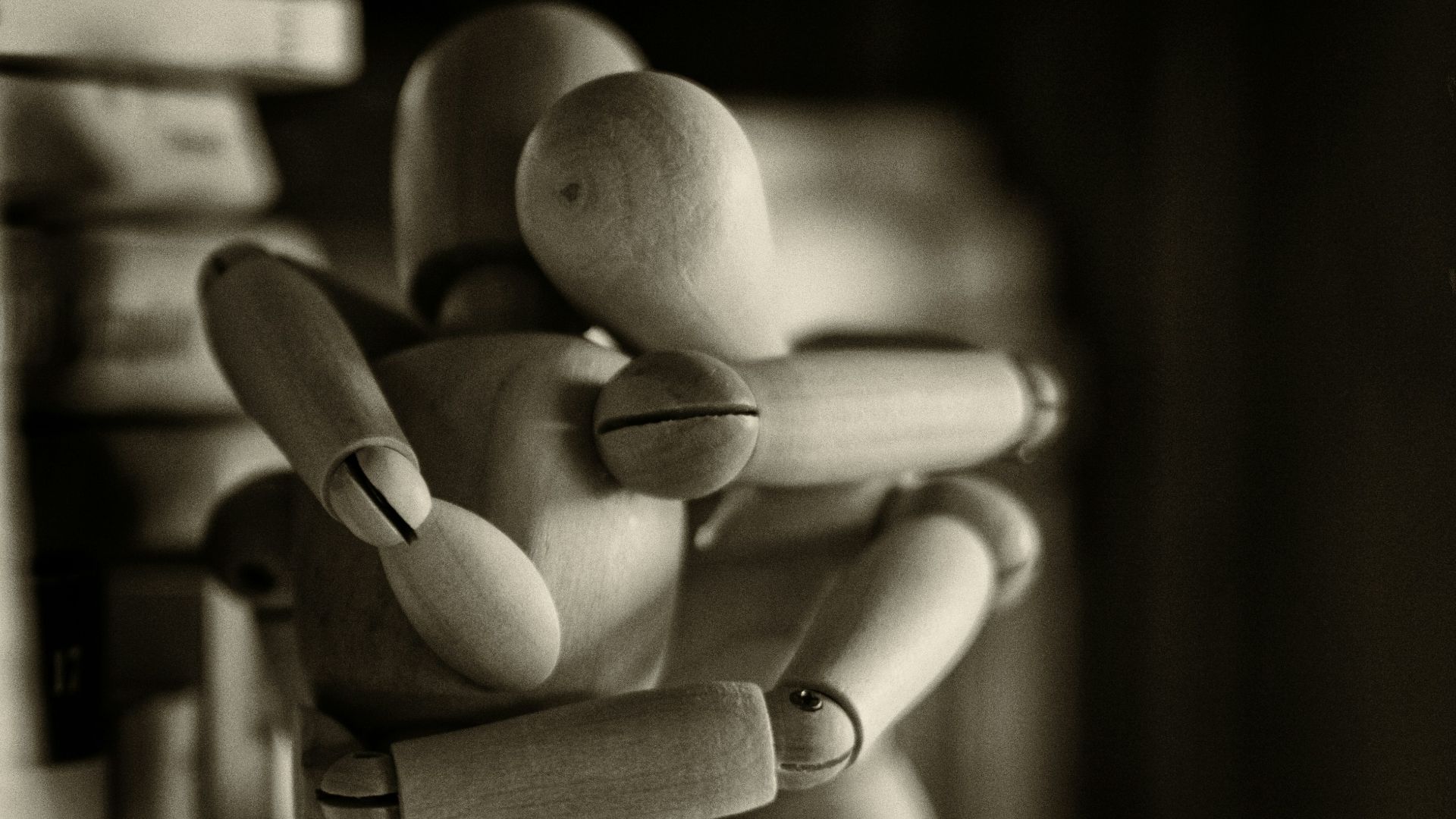 two wooden dummy hugging figures